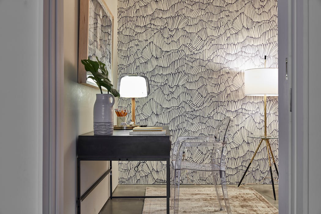 A small space is enhanced through the use of wallpaper. 