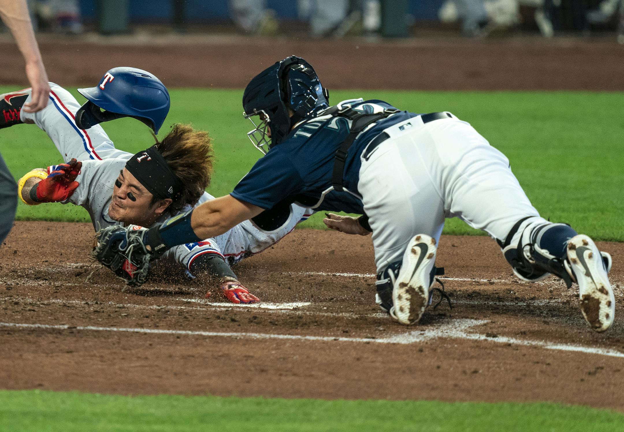 Texas Rangers' Shin-Soo Choo, left, touches home plate to score before Seattle Mariners catcher Luis Torrens, right, can make a tag on a two-run double by Rangers' Joey Gallo off Mariners starting pitcher Marco Gonzales during the fourth inning of a baseball game, Monday, Sept. 7, 2020, in Seattle. (AP Photo/Stephen Brashear)