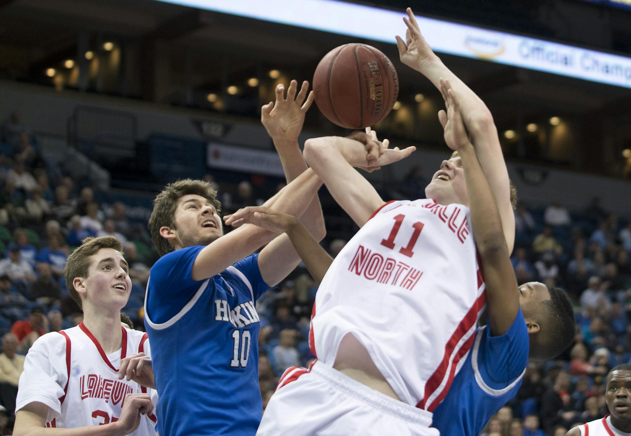 Hopkins forward Graham Hutson (10) grabs the wrist of Lakeville North guard Trevor Schermann (11) for a personal foul in the final minutes of the second half. ] (Aaron Lavinsky | StarTribune) Lakeville North plays Hopkins in the Class 4A boys' basketball quarterfinals on Wednesday, March 11, 2015 at Target Center.