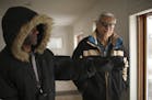 Mahmoud Khan with a member of his maintenance crew, Melvin Snoddy, left, in one of his former rental properties in north Minneapolis Monday afternoon.