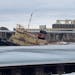 The decommissioned tug Lake Superior is seen sinking into the Duluth Harbor Monday.