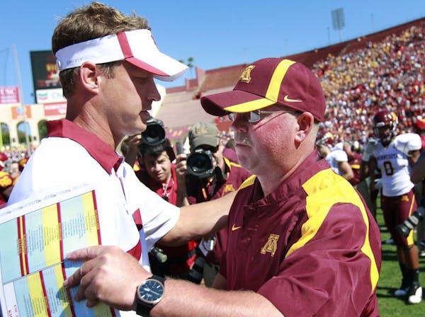 Minnesota head coach Jerry Kill shook hands with USC head coach Lane Kiffin at the end of the game. USC beat Minnesota by a final score of 19-17.