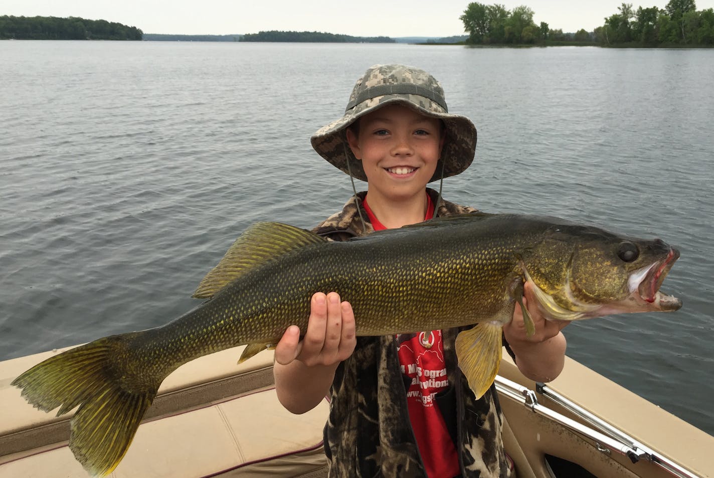 Sam Fulton, 10, of Edina, with a monster walleye he caught on Lake Pokegama.