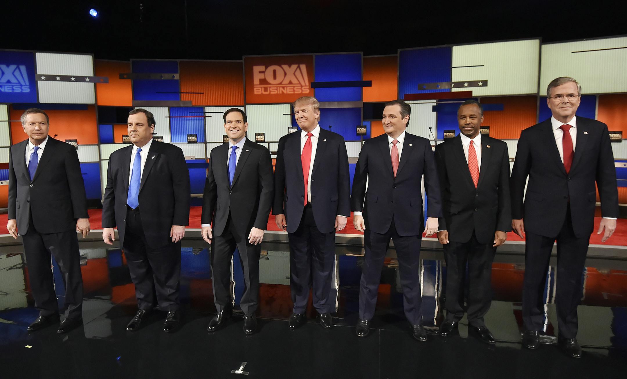 Republican presidential candidates, from left, Ohio Gov. John Kasich, New Jersey Gov. Chris Christie, Sen. Marco Rubio, R-Fla., businessman Donald Trump, Sen. Ted Cruz, R-Texas, retired neurosurgeon Ben Carson and former Florida Gov. Jeb Bush take the stage before the Fox Business Network Republican presidential debate at the North Charleston Coliseum, Thursday, Jan. 14, 2016, in North Charleston, S.C. (AP Photo/Rainier Ehrhardt) ORG XMIT: MIN2016011512294125