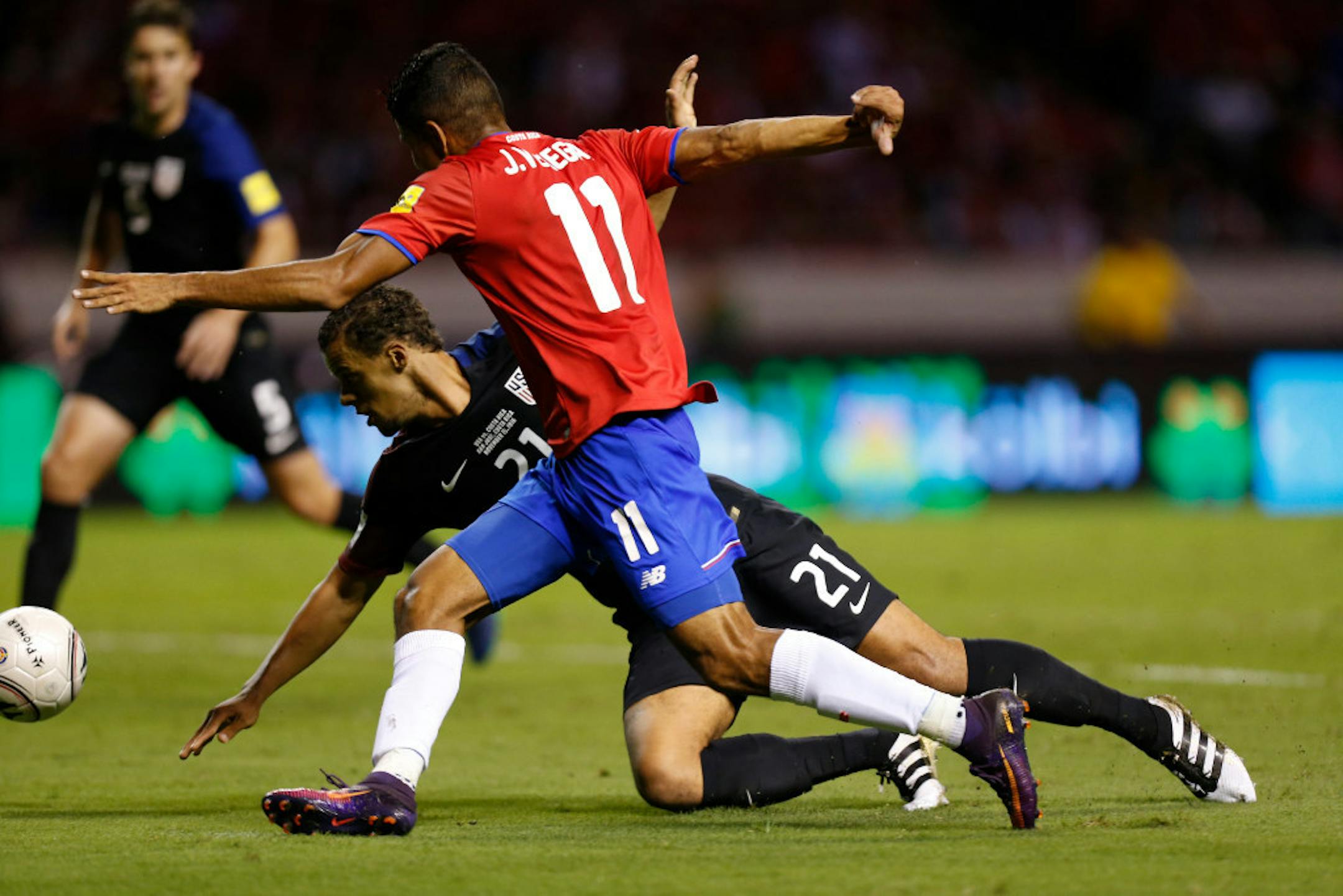 Costa Rica's Johan Venegas (11) and United States' Timothy Chandler fight for the ball during a 2018 World Cup qualifying soccer match in San Jose, Costa Rica, Tuesday, Nov. 15, 2016. (AP Photo/Moises Castillo)