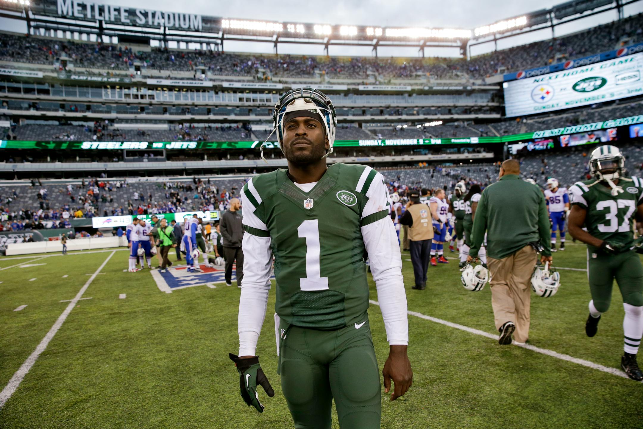 New York Jets quarterback Michael Vick (1) walks off the field after an NFL football game against the Buffalo Bills Sunday, Oct. 26, 2014, in East Rutherford, N.J. The Bills won the game 43-23. (AP Photo/Seth Wenig)
