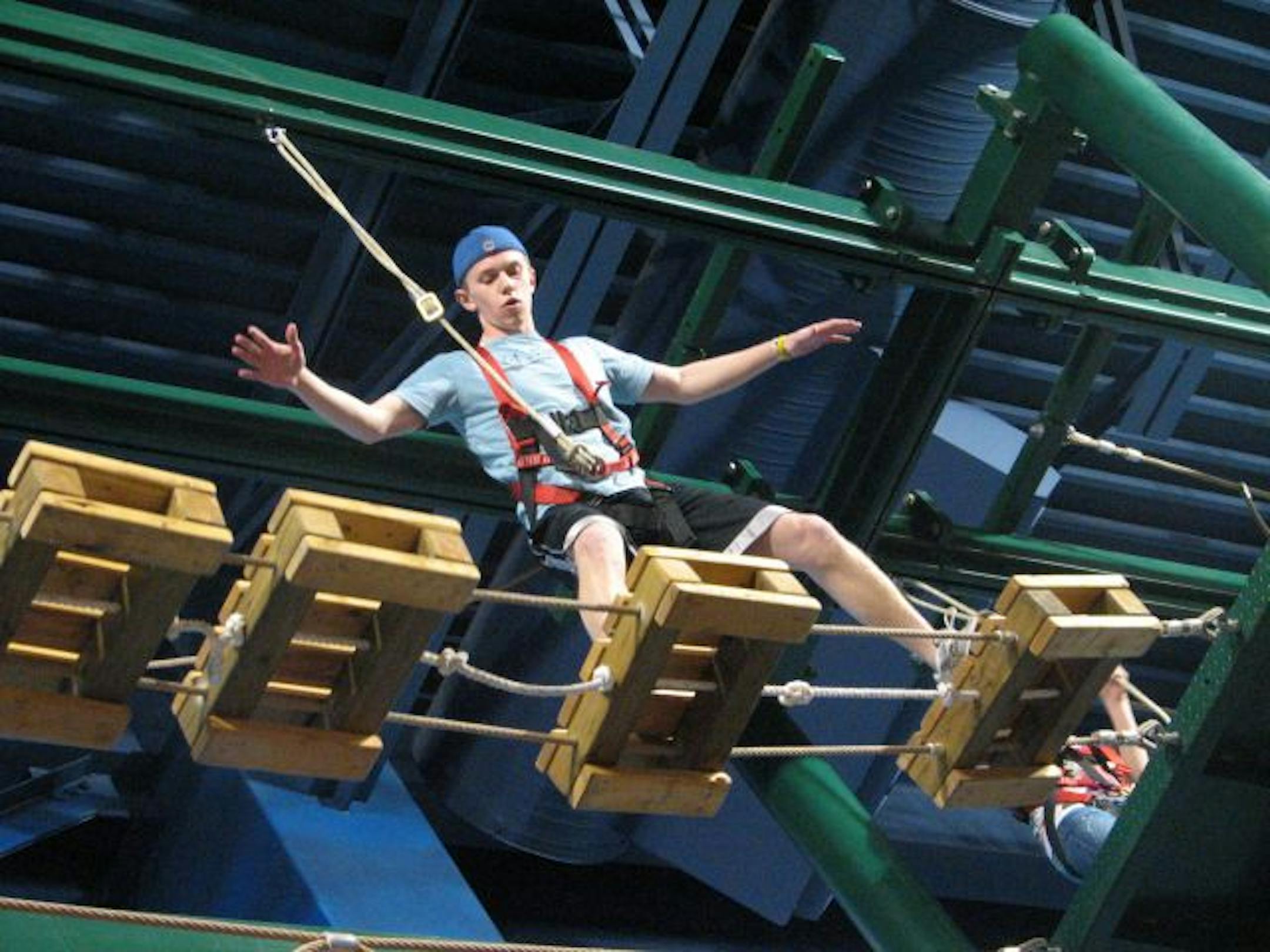 Tim McManus negotiates one of the segments on the ropes course at Kalahari's new Indoor Theme Park in the Wisconsin Dells. A new 110,000-square-foot amusement park connects the resort to a neighboring movie theater and restaurant, creating a sprawling, mini universe of indoor fun.