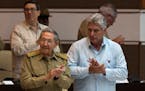 Cuba's President Raul Castro, left, and Cuba's Vice President Miguel Diaz Canel applaud during the National Assembly in Havana, Cuba, Friday, July 8, 