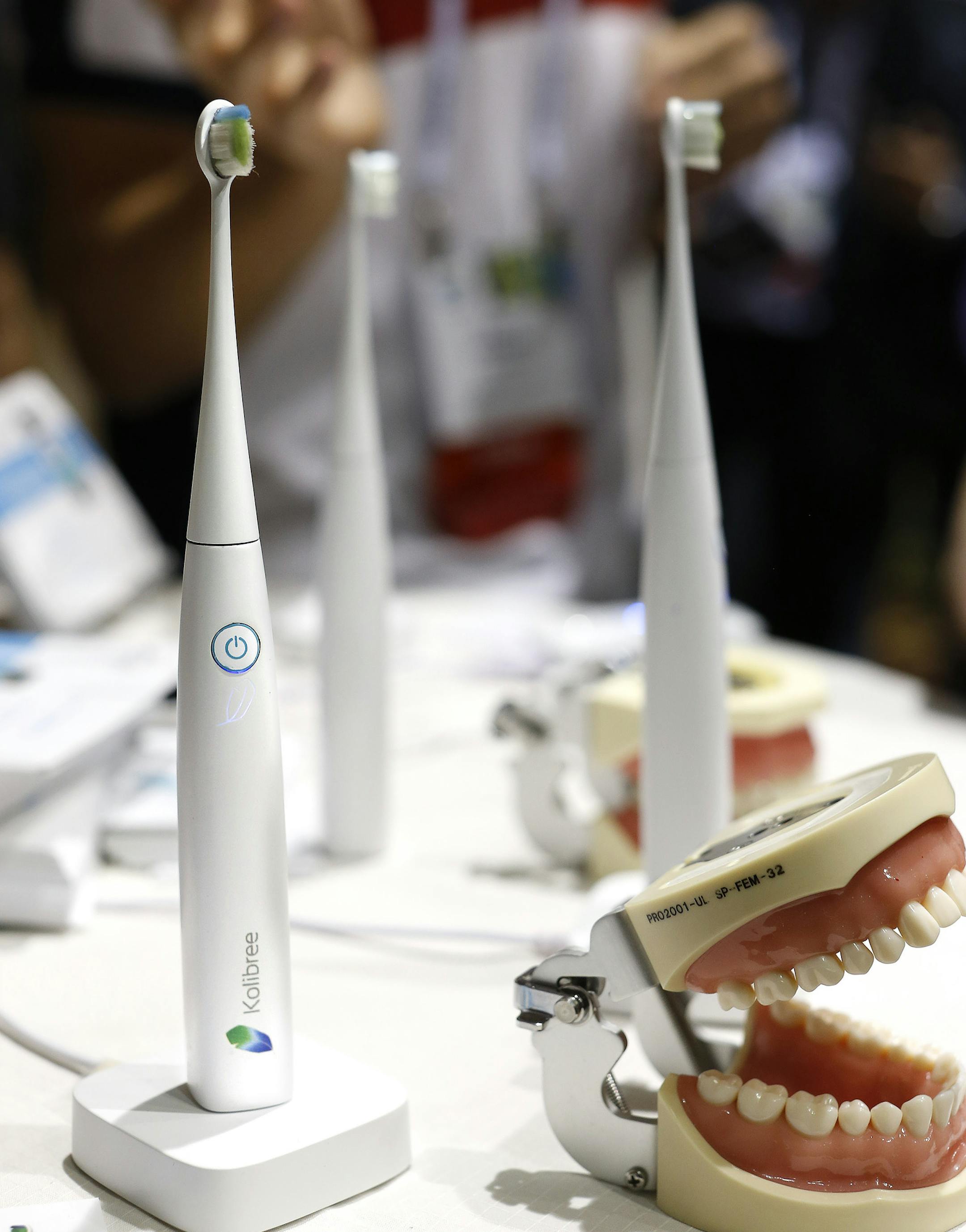 The Kolibree toothbrush sits on display at the International Consumer Electronics Show, Sunday, Jan. 5, 2014, in Las Vegas. Using Bluetooth wireless, the toothbrush senses how itís moved and can send the information to an Android phone or iPhone and will be able to teach you to brush right and long enough. (AP Photo/Julie Jacobson)