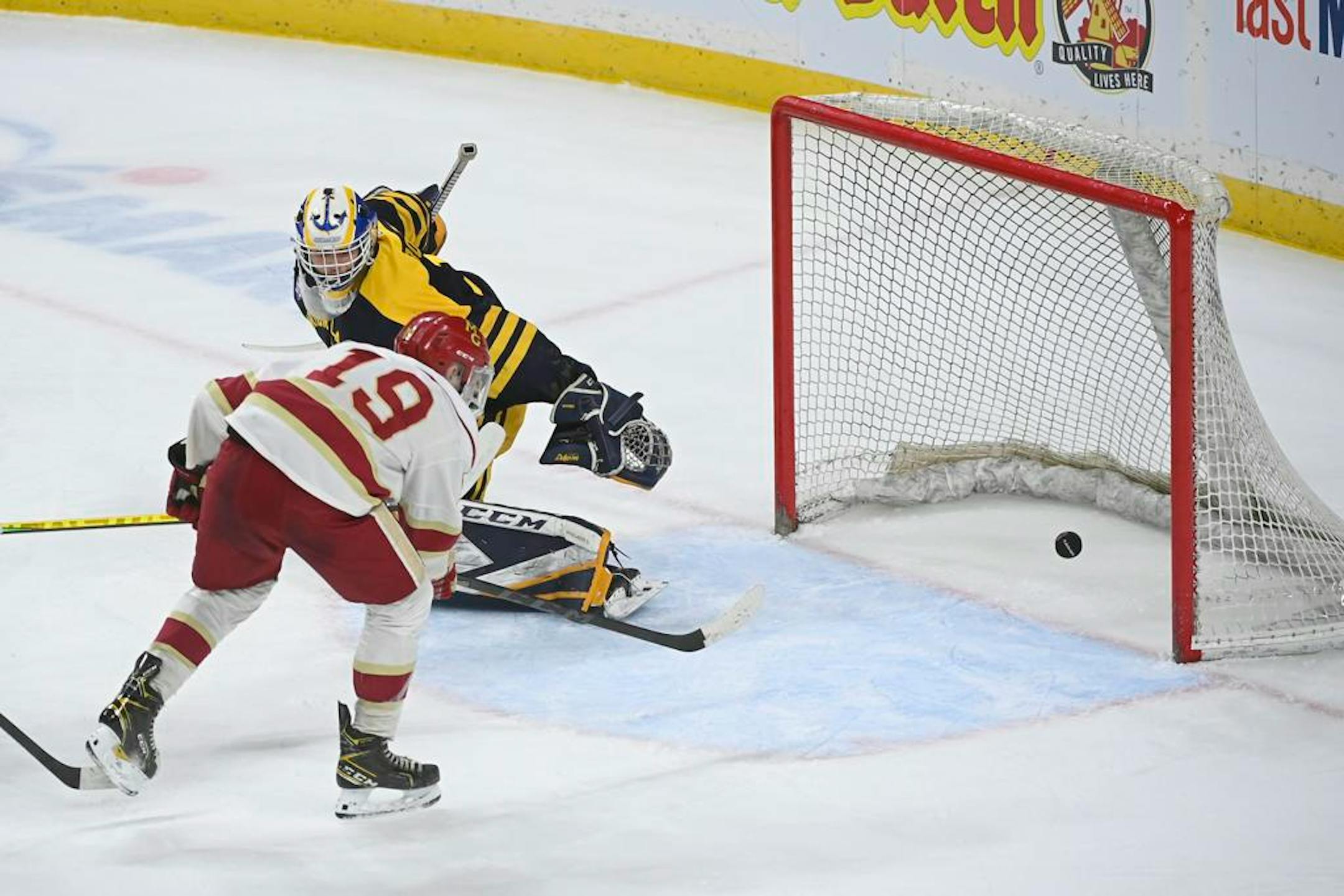 Maple Grove forward Joshua Giuliani (19) scores his hat trick point against Prior Lake goaltender Trevor Boschee (1) in the second period during a Class 2A State Tournament semifinal game Friday, March 11, 2022 at the Xcel Energy Center in St. Paul, Minn. ] AARON LAVINSKY • aaron.lavinsky@startribune.com