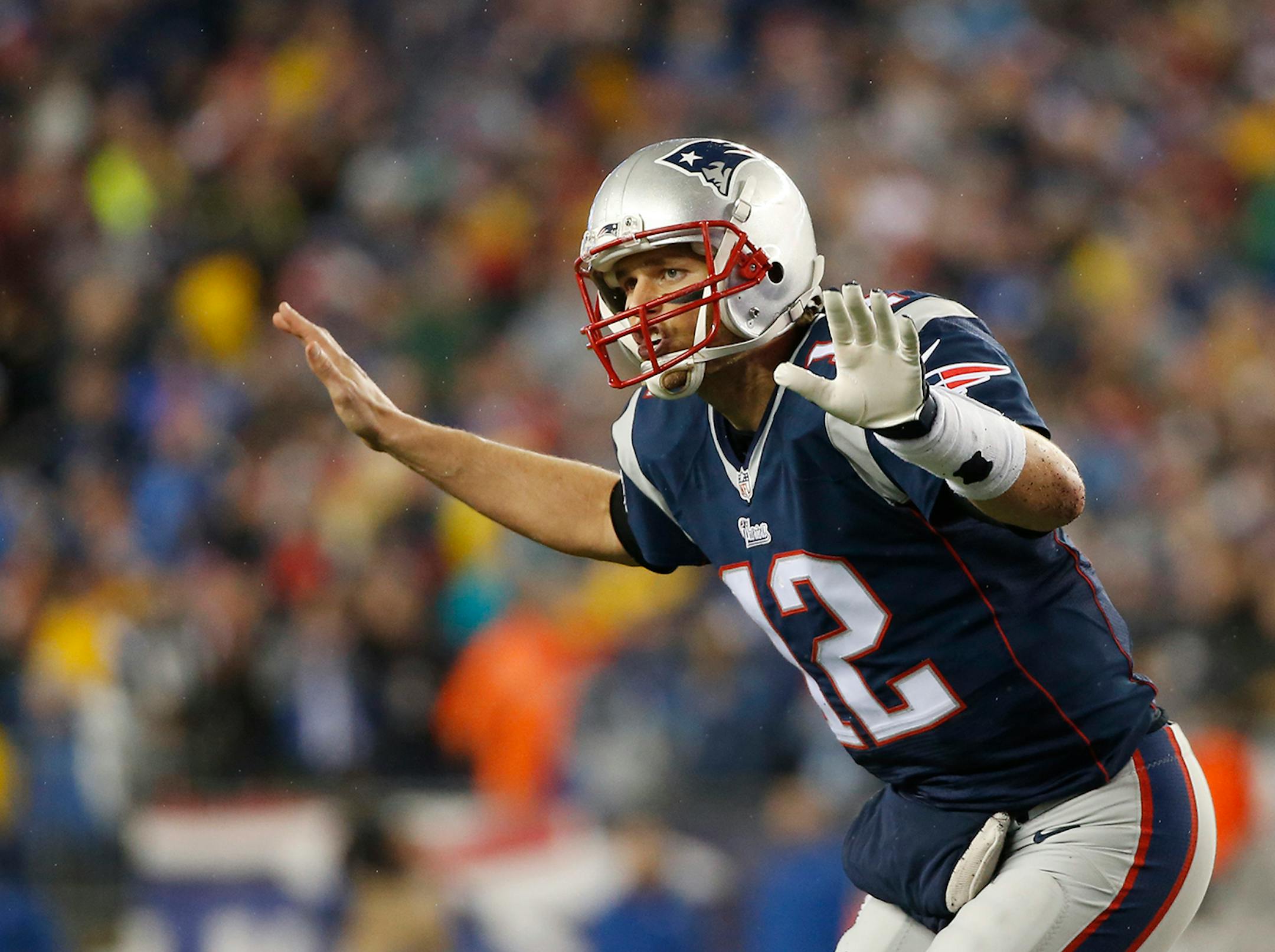 New England Patriots quarterback Tom Brady (12) calls a play during the first half of the NFL football AFC Championship game against the Indianapolis Colts Sunday, Jan. 18, 2015, in Foxborough, Mass. (AP Photo/Elise Amendola)