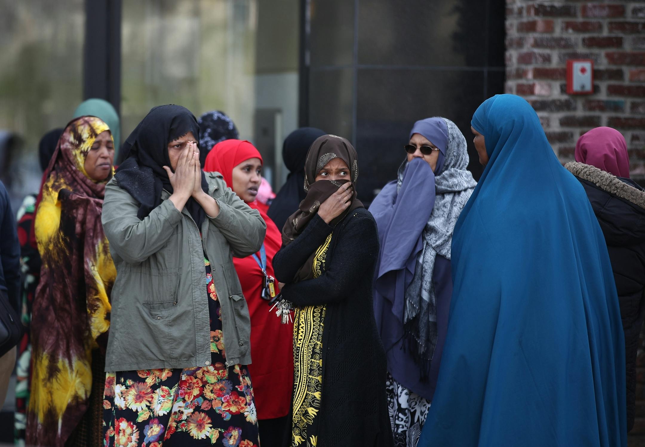 Women gathered outside of the Karmel Village Apartments after two children fell from an apartment building at S. 28th and Pleasant Avenue Thursday May 2, 2019 in Minneapolis, MN.