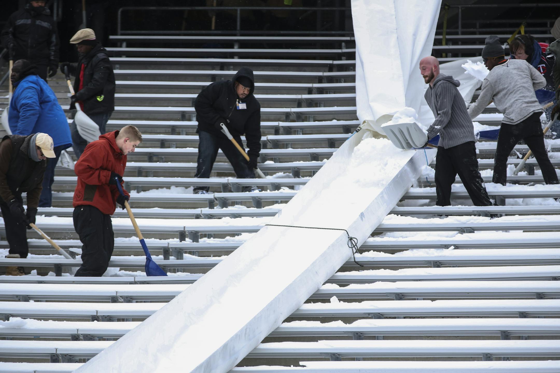 TCF Bank Stadium is buried in snow that must be removed by Saturday for the Gophers football game. People were hired to remove it on Wednesday, November 12, 2014 in Minneapolis, Minn. They used long chute to slide it down into the field to be hauled away. ] RENEE JONES SCHNEIDER • reneejones@startribune.com