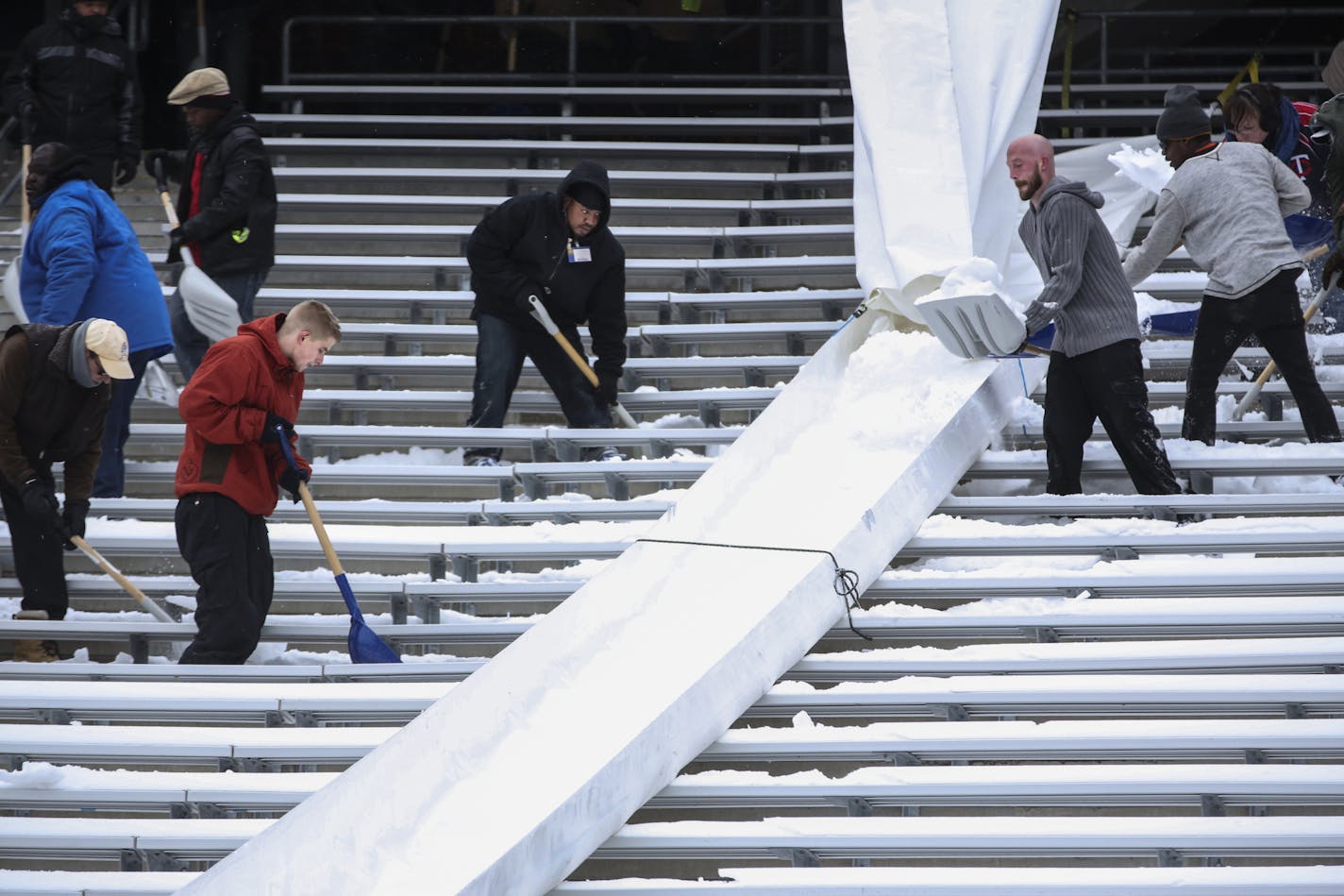 TCF Bank Stadium is buried in snow that must be removed by Saturday for the Gophers football game. People were hired to remove it on Wednesday, November 12, 2014 in Minneapolis, Minn. They used long chute to slide it down into the field to be hauled away. ] RENEE JONES SCHNEIDER &#x2022; reneejones@startribune.com