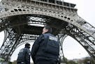Police forces on patrol Saturday passed under the Eiffel Tower, which was closed in the wake of Friday's terrorist attacks in Paris.