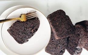 Delicious chocolate loaf cake with a knife resting on top, inspired by Sarah Kieffer's favorite chocolate cake recipe.
