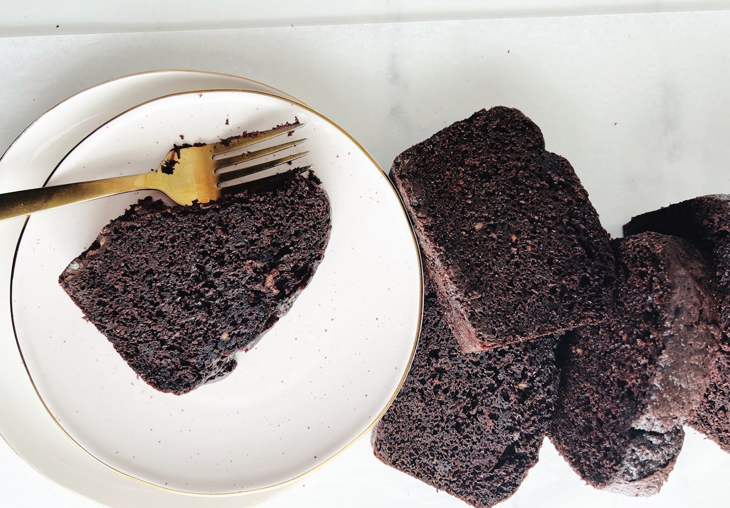 Delicious chocolate loaf cake with a knife resting on top, inspired by Sarah Kieffer's favorite chocolate cake recipe.