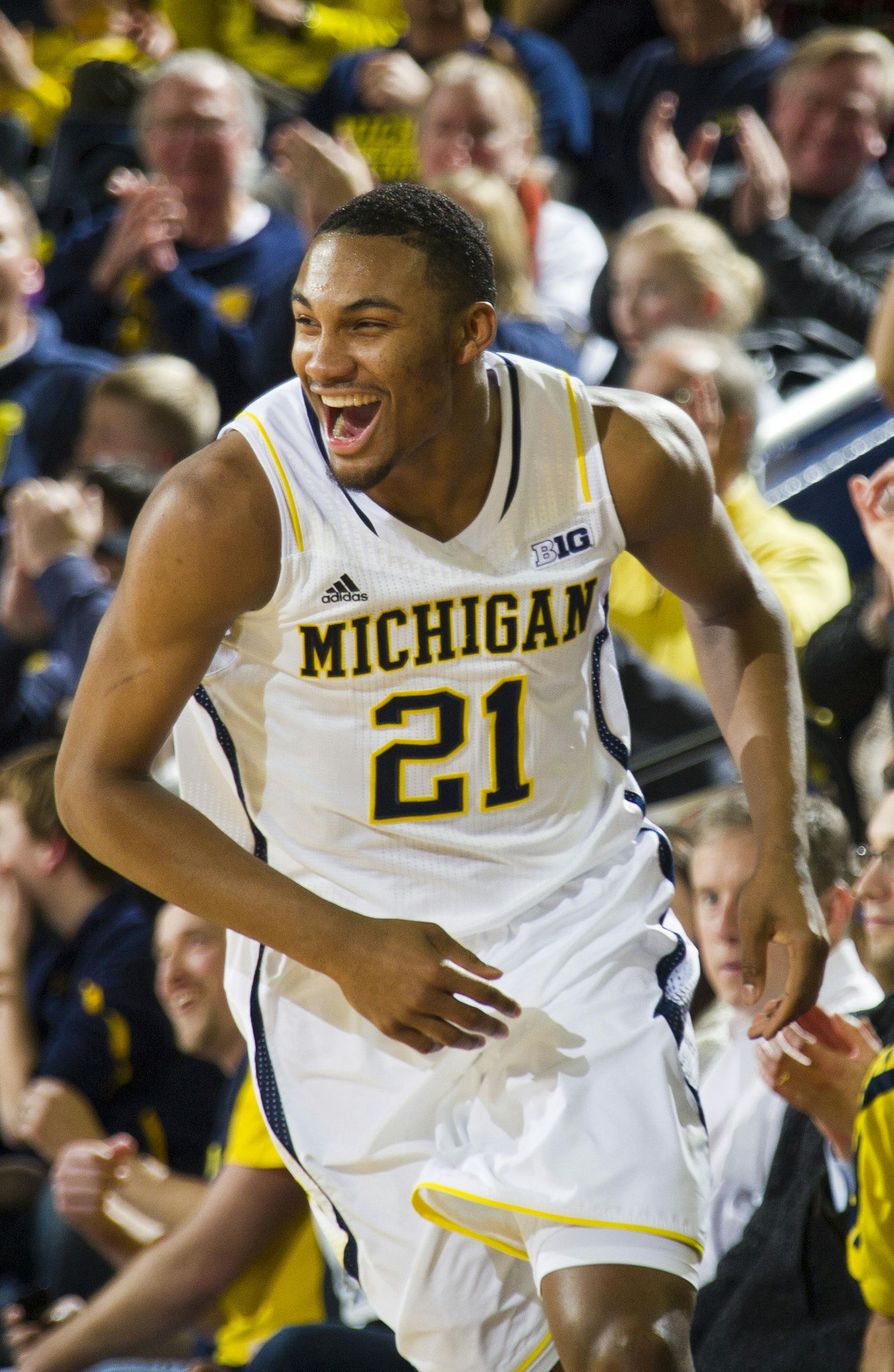 Michigan guard Zak Irvin (21) celebrates a 3-point basket in the first half of an NCAA college basketball game against Nebraska in Ann Arbor, Mich., Wednesday, Feb. 5, 2014. (AP Photo/Tony Ding)