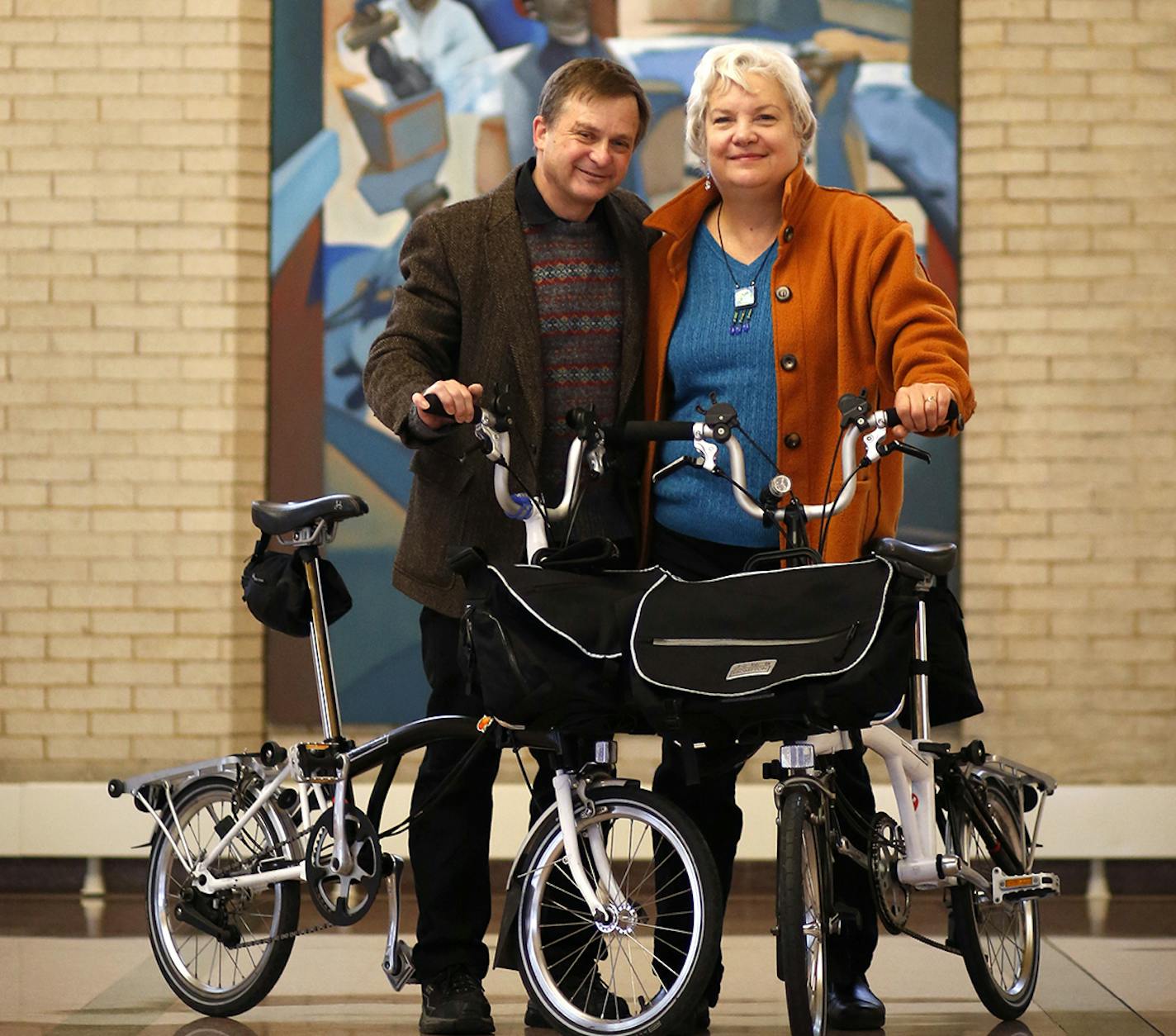 Ken and Roberta Avidor pose with their travel bikes at Union Depot in downtown St. Paul on Friday, December 26, 2014. ] LEILA NAVIDI leila.navidi@startribune.com / BACKGROUND INFORMATION: Ken and Roberta Avidor, who live in a condo in Union Depot, are part of the Twin Cities growing urban-sketching movement, they have captured Mississippi River flooding, people waiting at bus stops and, most recently, life on St. Paul's Green Line light rail trains.