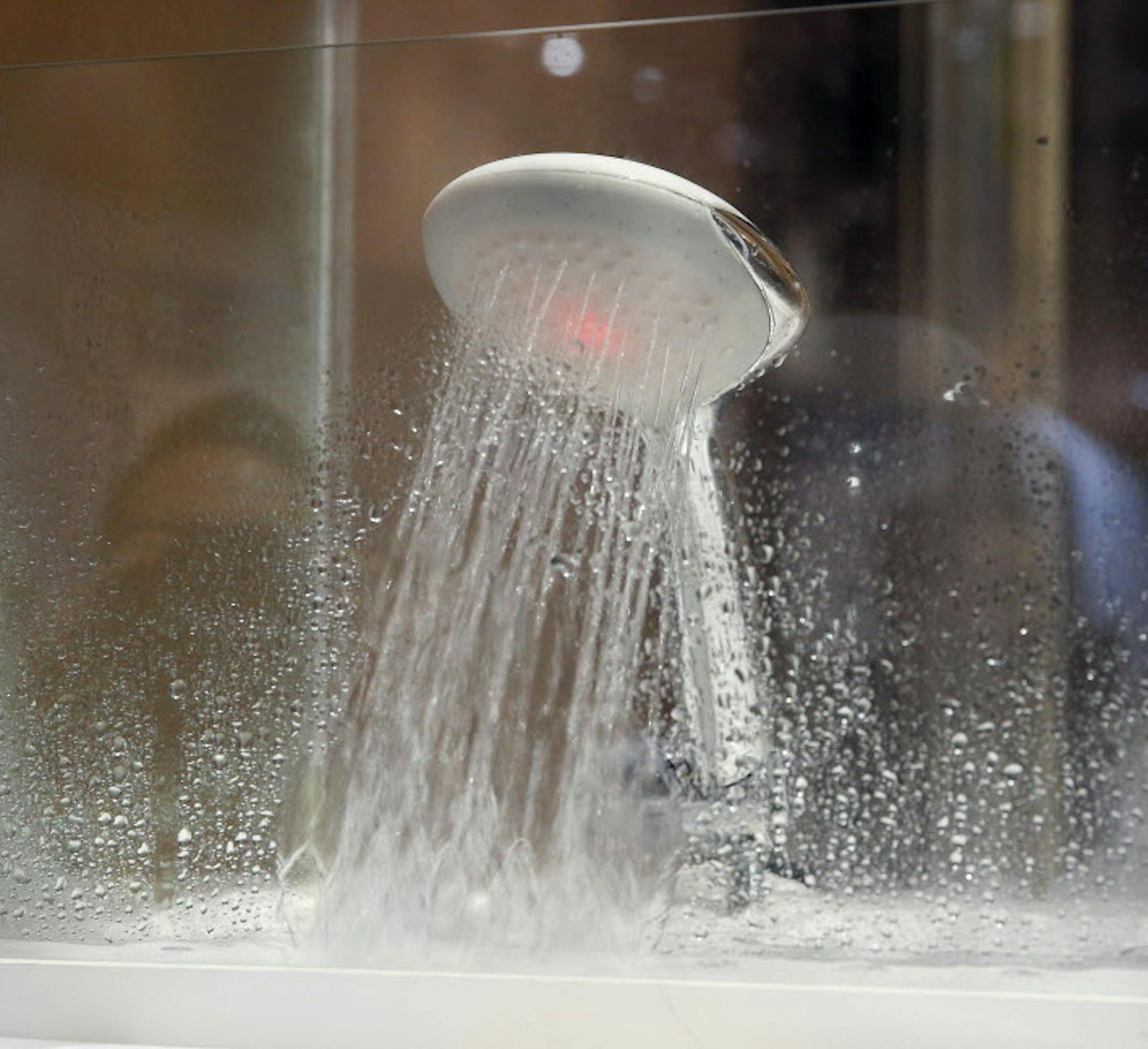 The Hydrao Eco-Sensitive Smart Shower is on display at CES Unveiled, a media preview event for CES International, Monday, Jan. 4, 2016, in Las Vegas. The shower records water usage on an app for a mobile device and can light up in different colors to notify the user of amount of water used. (AP Photo/John Locher)