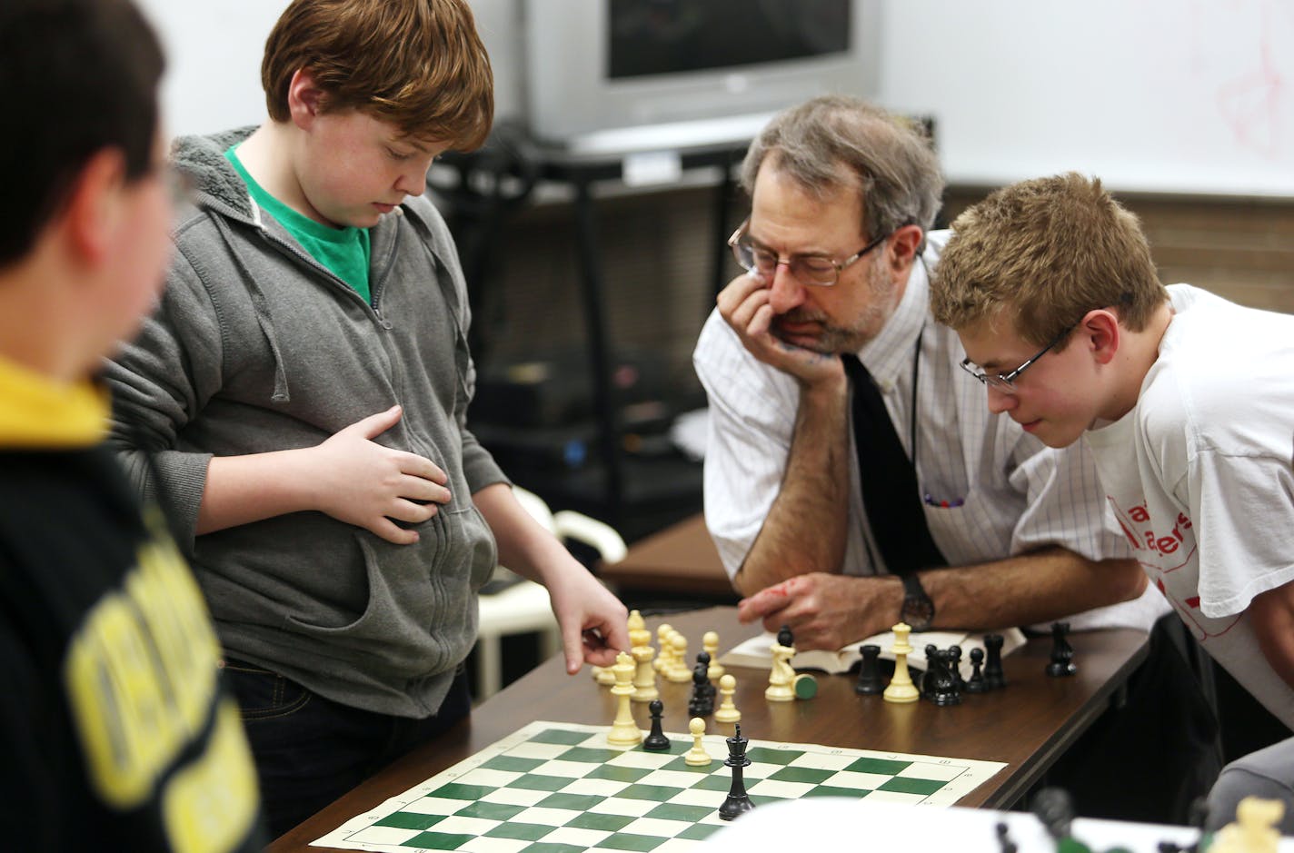 Seventh graders Josh Holtzleiter (grey sweat shirt/green t-shirt) and Josh Holtzleiter (white shirt) work with teacher/chess instructor Brian Ribnick on the End Game at Burnsville Junior High. ] JOELKOYAMA&#x201a;&#xc4;&#xa2;jkoyama@startribune Burnsville, MN on April 8, 2014. The Burnsville chess program has existed for decades and become an integral part of the district's identity. The junior high chess team in particular does very well and recently won the state title again. Chess is integrat