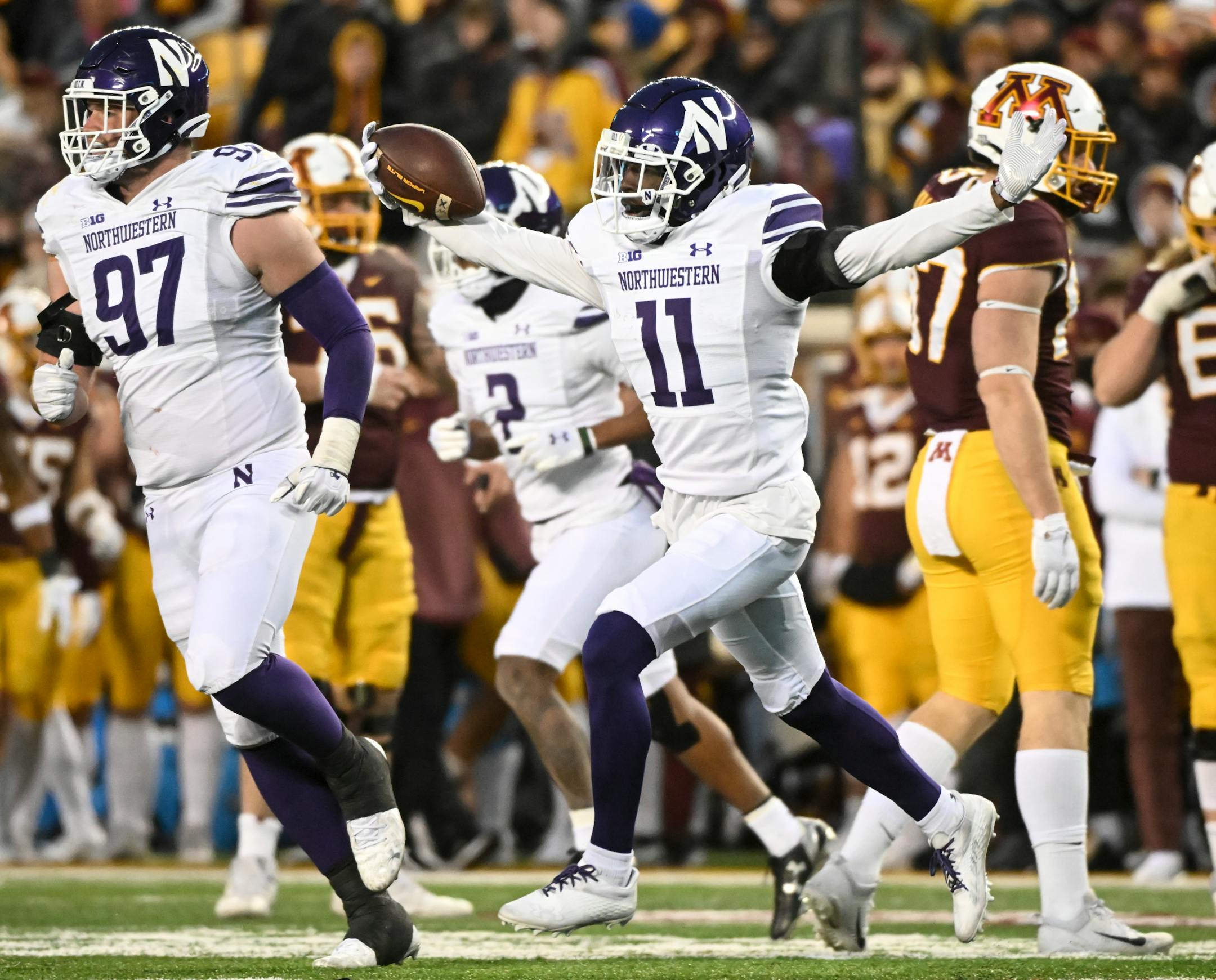 Northwestern Wildcats defensive back A.J. Hampton Jr. (11) celebrates after recovering the ball fumbled by Minnesota Gophers wide receiver Dylan Wright (5) during the second half.