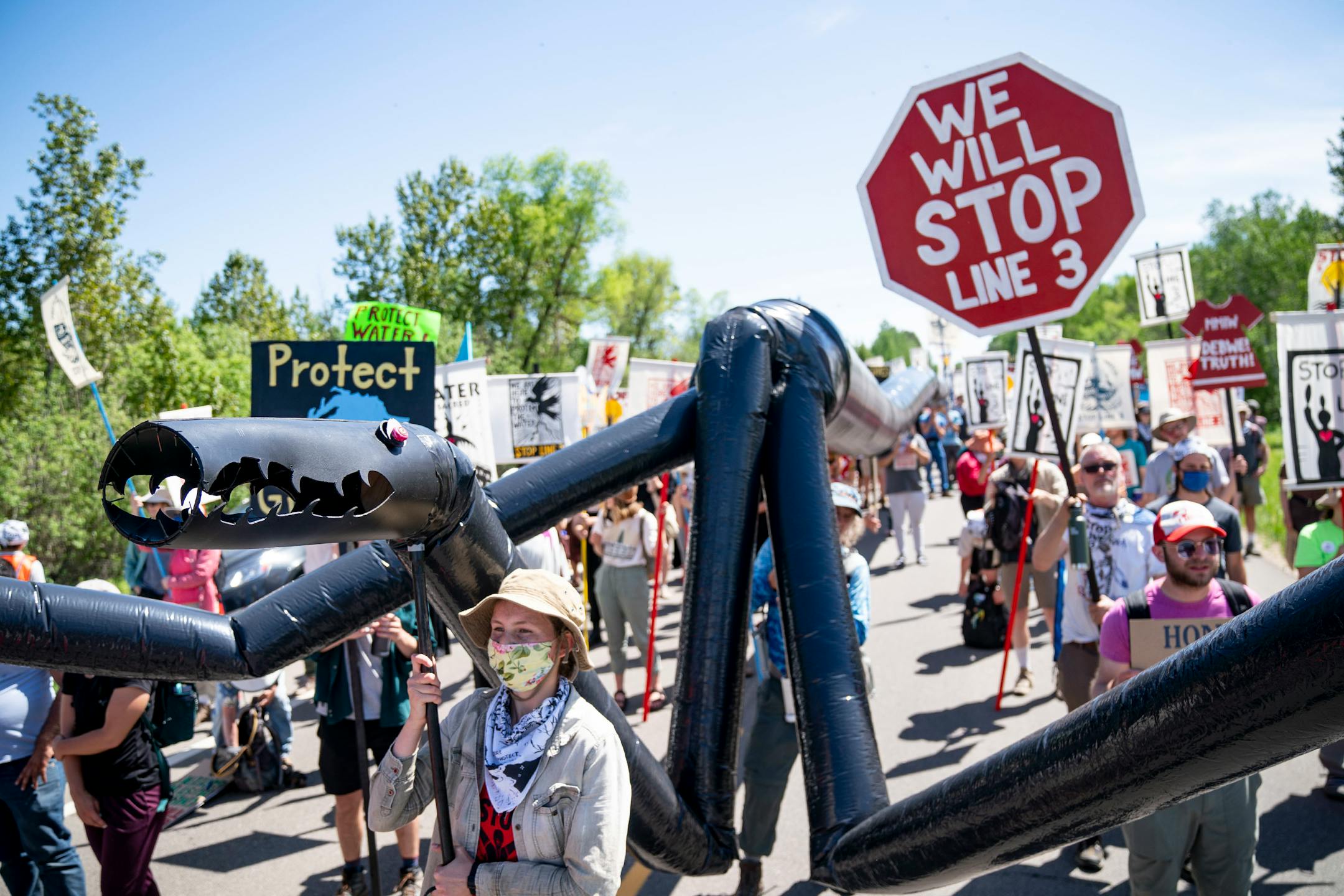 A makeshift black snake resembling a pipeline was carried as 2,000 indigenous leaders and water protectors from around the country marched along Highway 9 in Clearwater County, Minn. on Monday, June 7, 2021 to protest the construction of Enbridge Line 3.