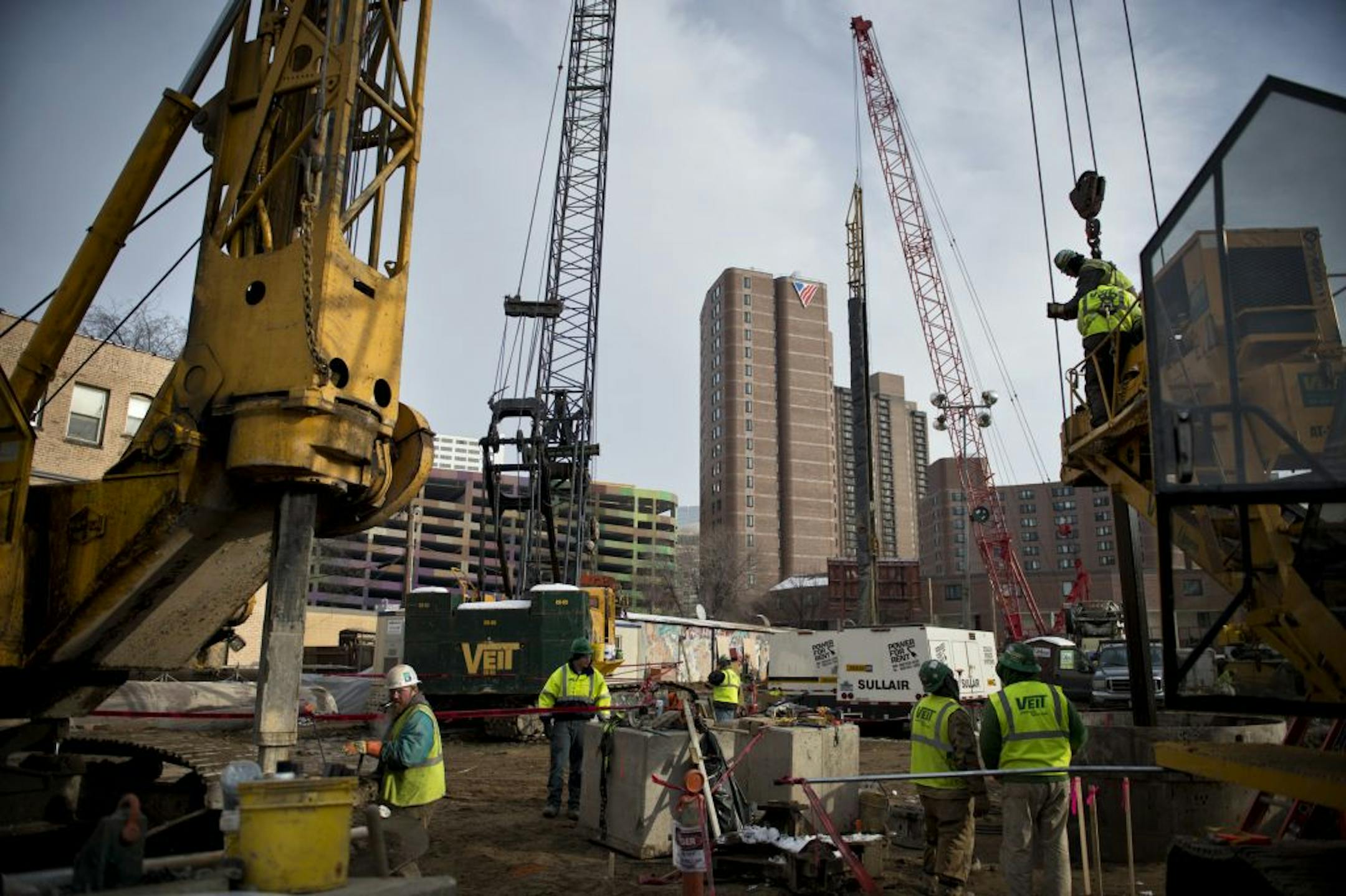 Workers from Veit Construction drilled holes for foundation supports Friday, December 14, 2012 at what will become a 36-story apartment building near Loring Park in Minneapolis.
