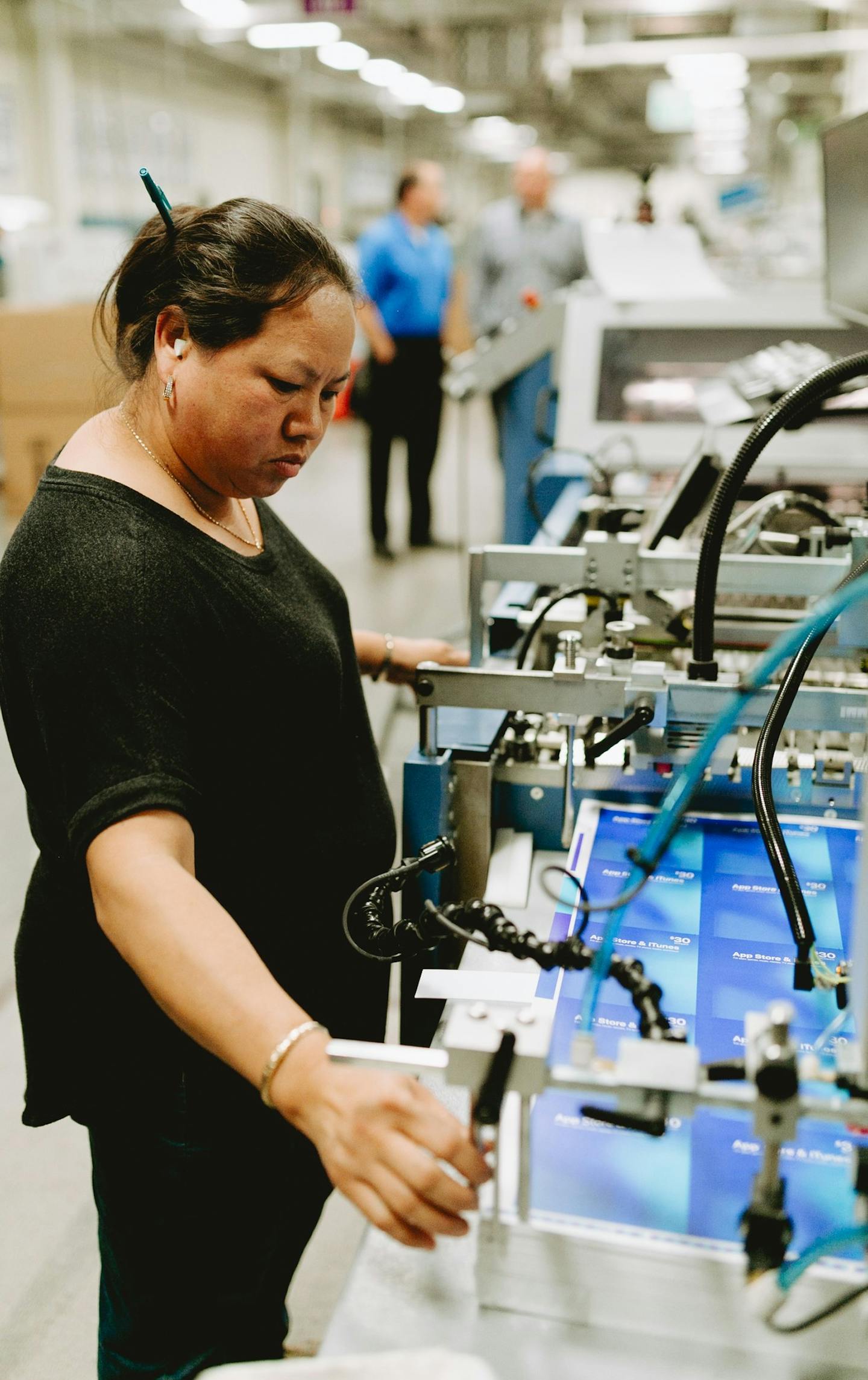 Mai Yang runs a rotary die cutter at Travel Tags, a gift card manufacturer in Inver Grove Heights.