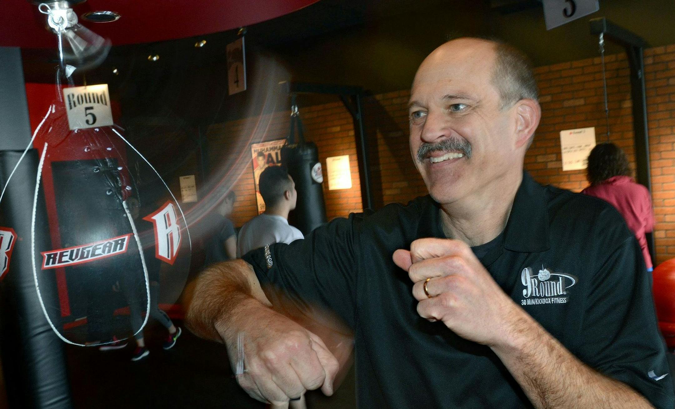 Dave deNeui cashed in a retirement fund to buy a 9Round franchise, a fitness center that offers a 30-minute kickbox workout with nine workout stations. He has opened two centers in Medina and Plymouth.He worked out at one of the nine stations at the Plymouth center.