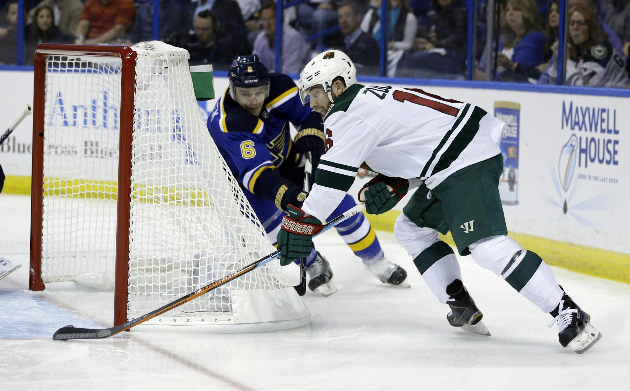 Minnesota Wild's Jason Zucker, right, scores past St. Louis Blues' Zbynek Michalek, of the Czech Republic, during the first period in Game 1 of an NHL hockey first-round playoff series, Thursday, April 16, 2015, in St. Louis. (AP Photo/Jeff Roberson)