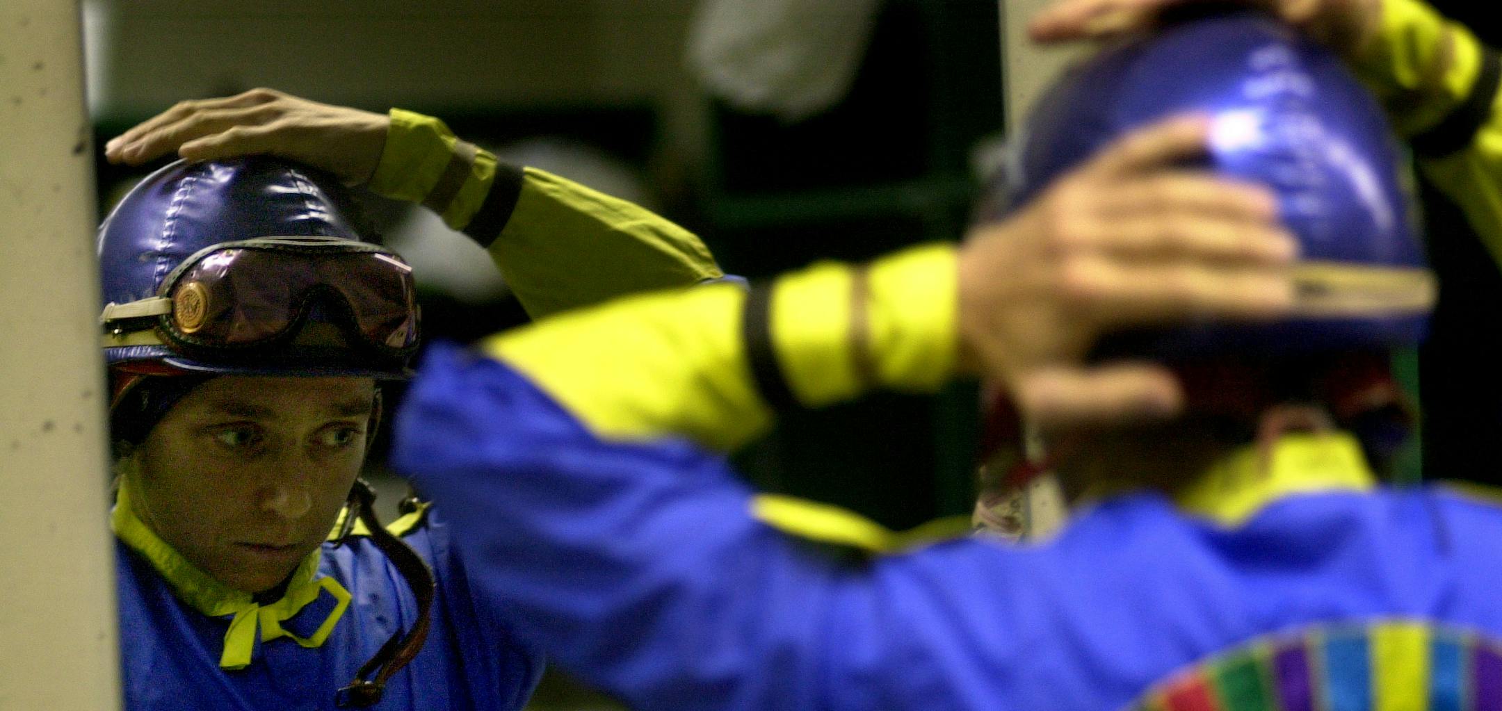 August 17, 2002 -- Shakopee, Mn -- Apprentice Jockeys -- After waiting hours for her one and only race of the day, apprentice jockey Anne Von Rosen gets ready to ride in the second to the last race of the evening. Von Rosen, originally from Germany, doesn't have an agent so it is difficult to find horses to ride. To make extra money, Von Rosen gallops horses in the mornings for trainers.