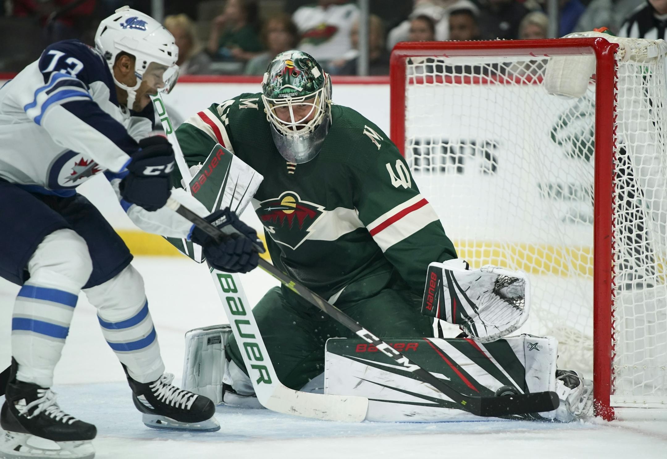 Minnesota Wild goaltender Devan Dubnyk stopped a second period shot by Winnipeg Jets left wing C.J. Suess (73).