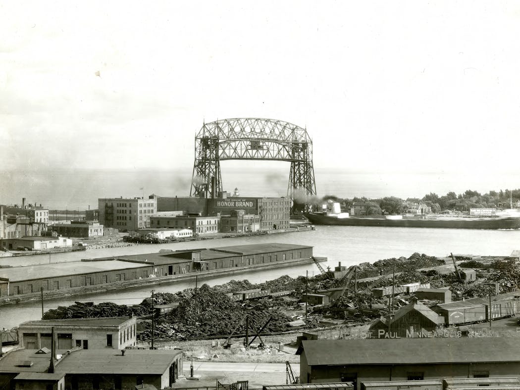A laker entered Duluth Harbor beneath the Aerial Lift Bridge in approximately the mid-1930s.