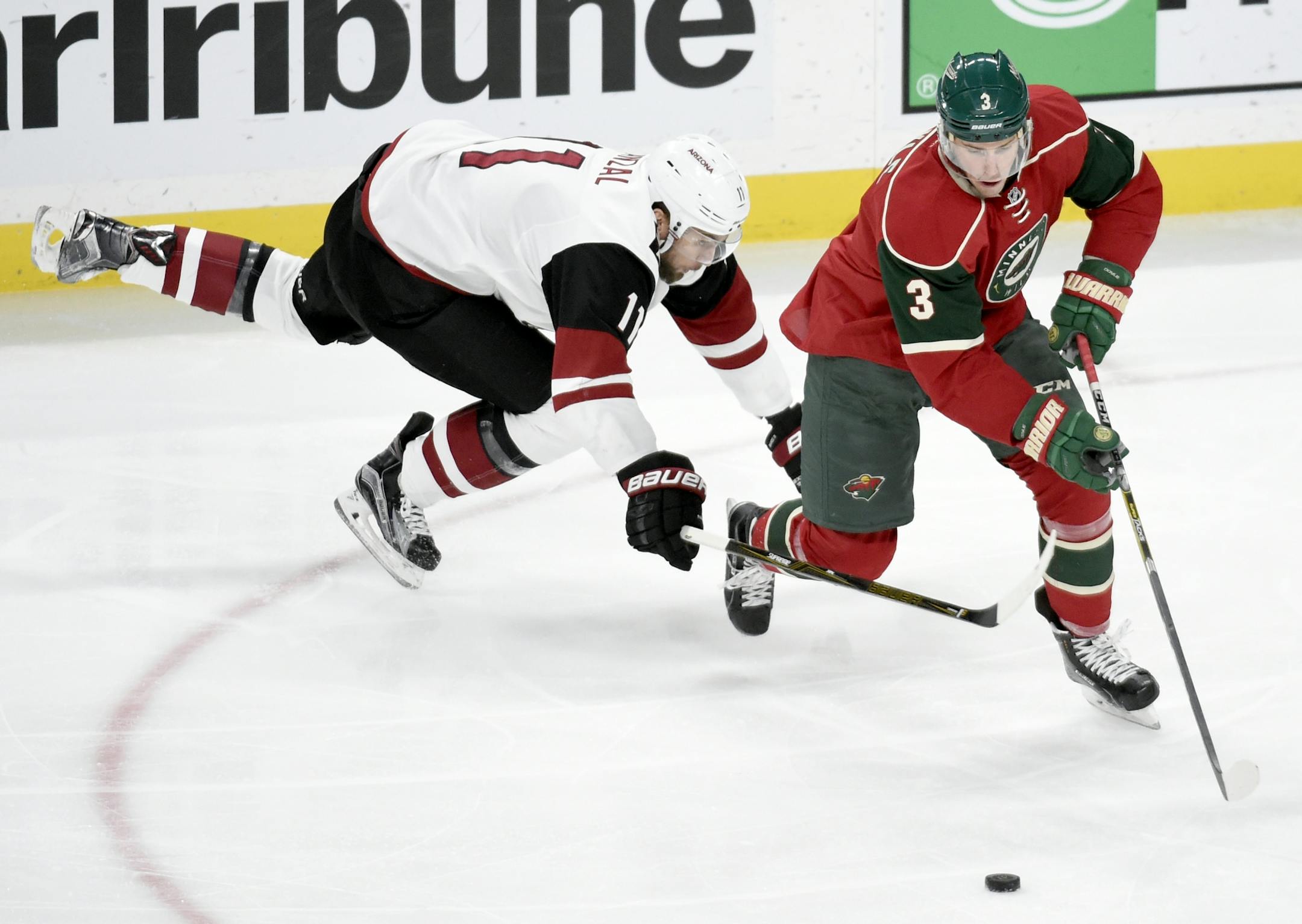 Minnesota Wild center Charlie Coyle (3) takes the puck against Arizona Coyotes center Martin Hanzal (11), of the Czech Republic, during the third period of an NHL hockey game, Saturday, Dec. 17, 2016, in St. Paul, Minn. The Wild won 4-1.