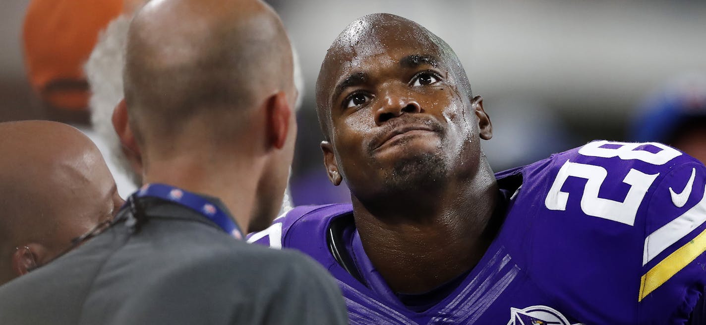 Minnesota Vikings running back Adrian Peterson (28) spoke with trainers on the sideline in the third quarter after leaving the game. ] CARLOS GONZALEZ cgonzalez@startribune.com - September 18, 2016, Minneapolis, MN, US Bank Stadium, NFL, Minnesota Vikings vs. Green Bay Packers