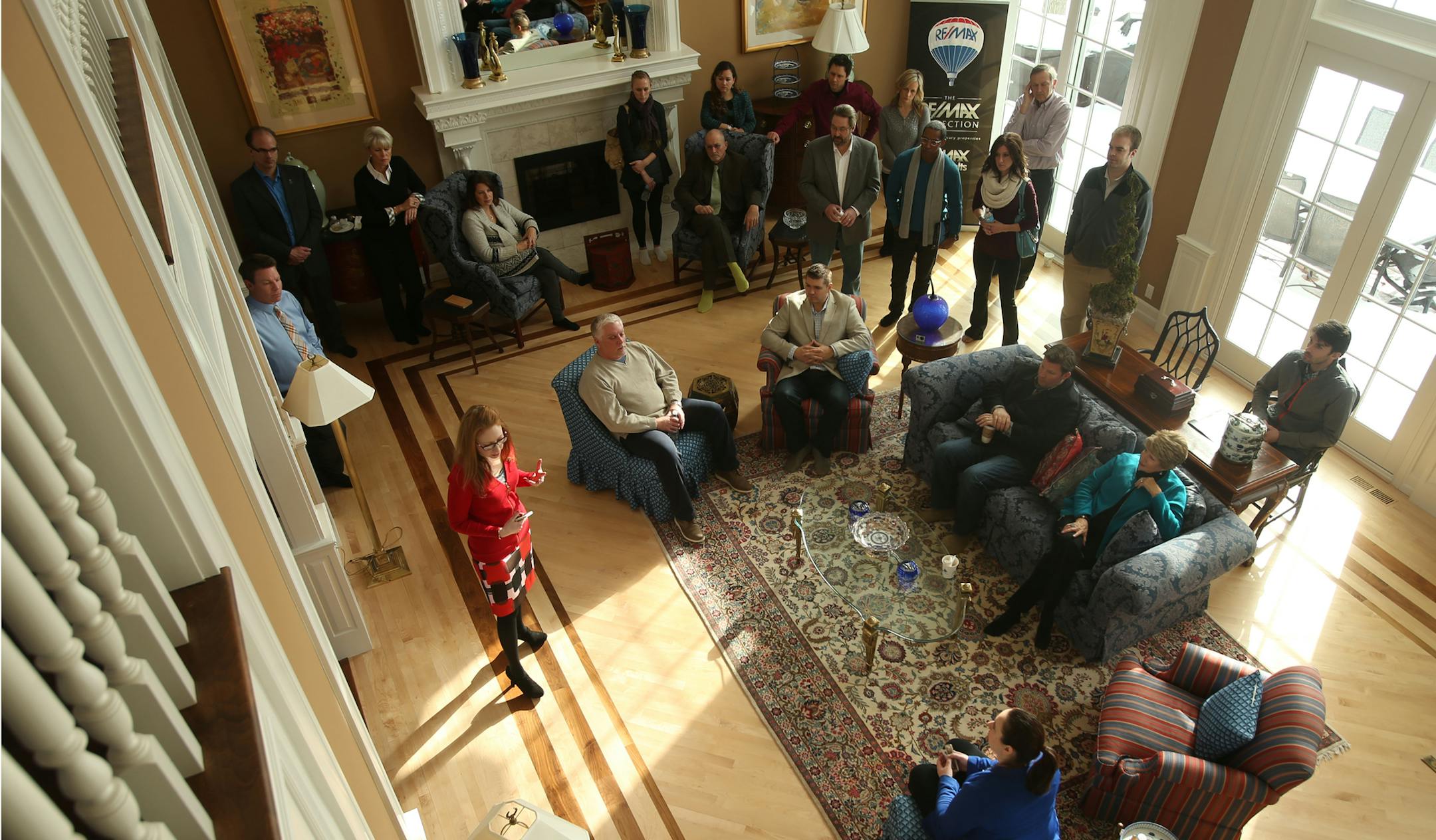 Julia Parenteau of the Minneapolis Area Association of Realtors, standing at left, discussed the real estate market with agents from Re/Max at a meeting Wednesday in Mound. As the weather warms up, real estate agents expect sales to pick up, too.