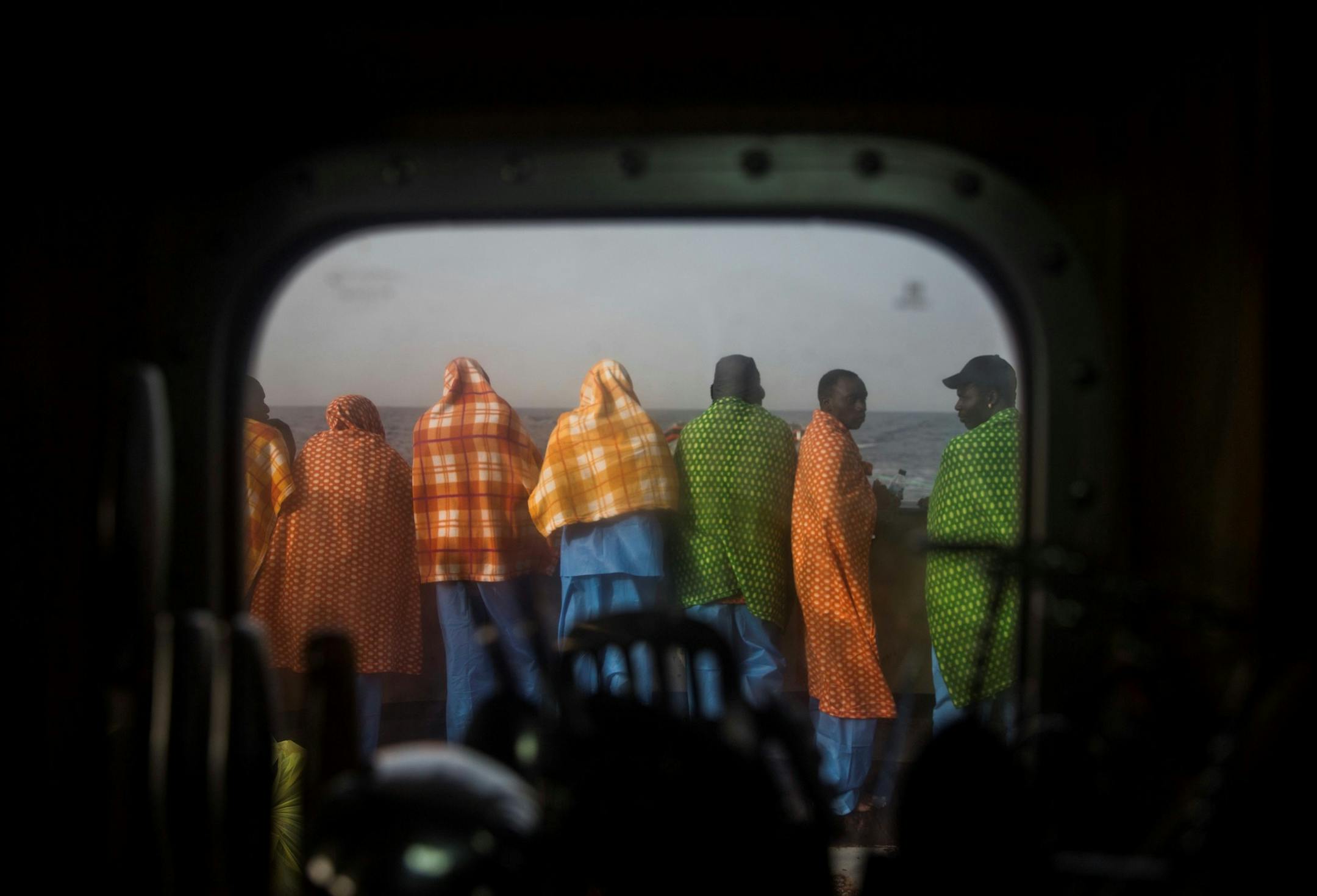African migrants, mostly from Sudan and Senegal, hold out hope that their trip will have a happy ending in Europe, but many times they do not. These men were rescued from a boat out of control off the Libyan coast in February 2016.