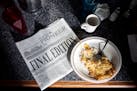 The final edition of the Warroad Pioneer sits on a table at the Daisy Gardens restaurant, where a customer was reading it over breakfast, in Warroad, 