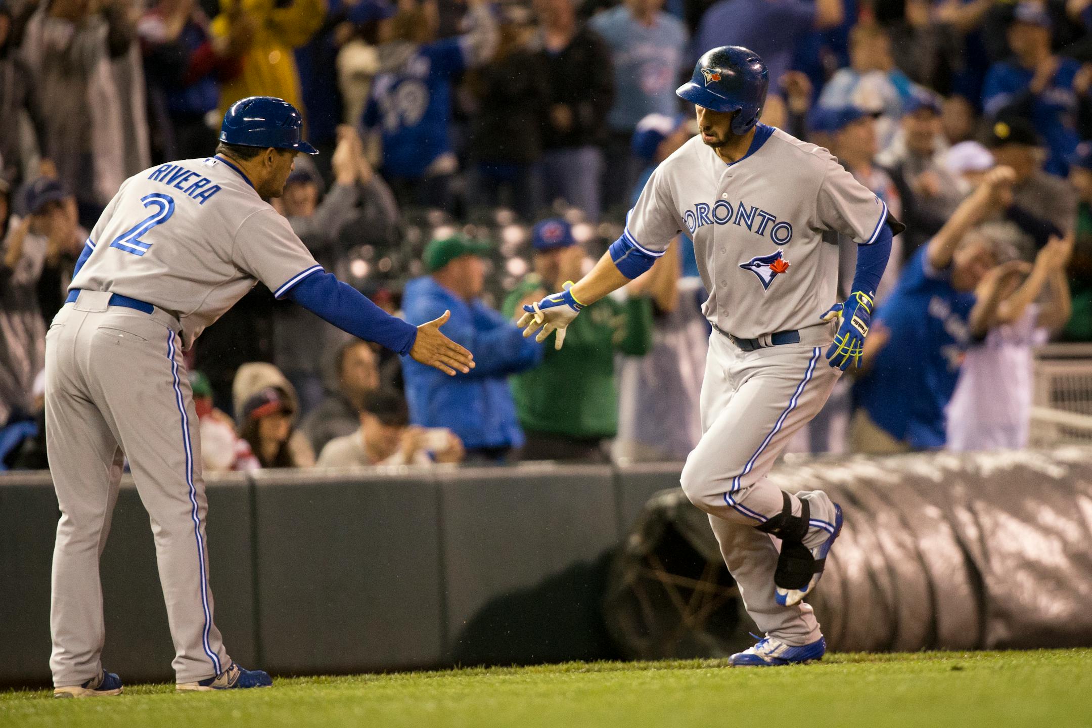 Chris Colabello high fived third base coach Luis Rivera as he rounded the bases after hitting a two-run homer in the top of the ninth against the Twins on Friday night.