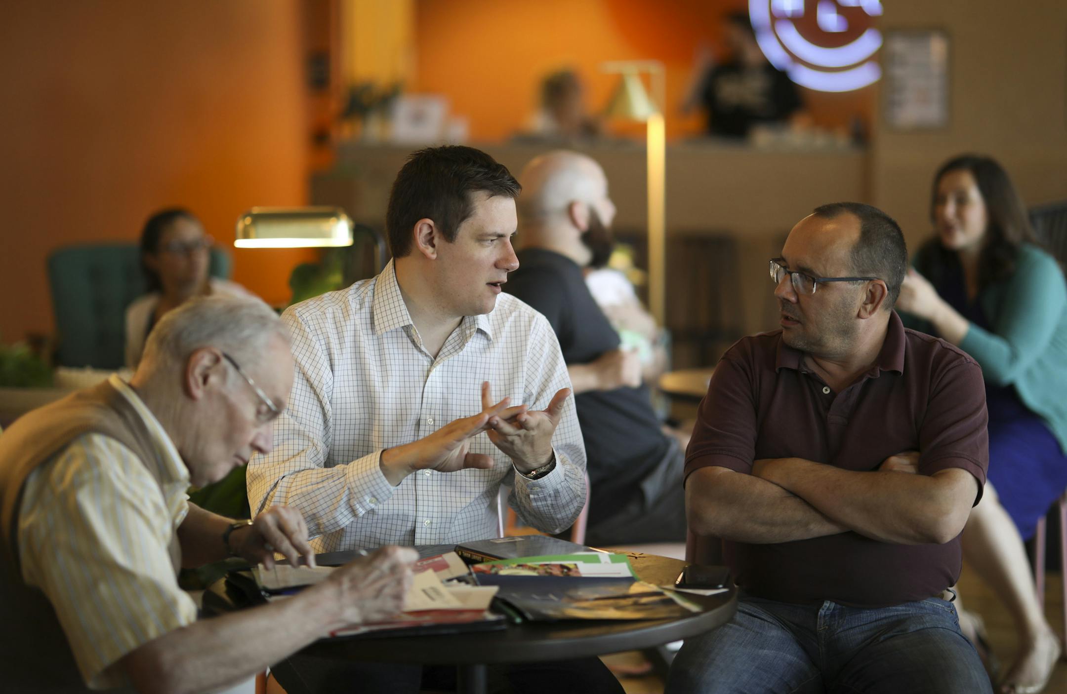 Starting 11 CEO & co-founder Teague Orgeman, center, visited with Peter Zugschwert, an investor, right, while Paul Taylor, a mentor and friend of the family boned up on soccer fantasy picks. ] JEFF WHEELER &#xef; jeff.wheeler@startribune.com Starting 11, a Minneapolis startup that runs fantasy league soccer apps in several countries, is having a big moment during the current World Cup. Co-founders Teague Orgeman and Amanda Heyman invited friends and investors to view England's World Cup match ag