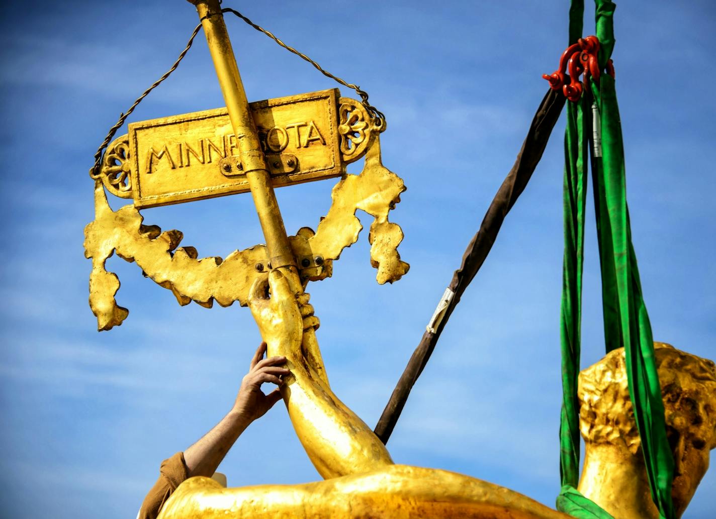 The charioteer figure who guides the golden horses on the Minnesota State Capitol Building's Quadriga statue were temporarily removed on Tuesday, September 23 to repair corrosion discovered at the statue's base. The repair is expected to take approximately three months when charioteer will return to the Quadriga.