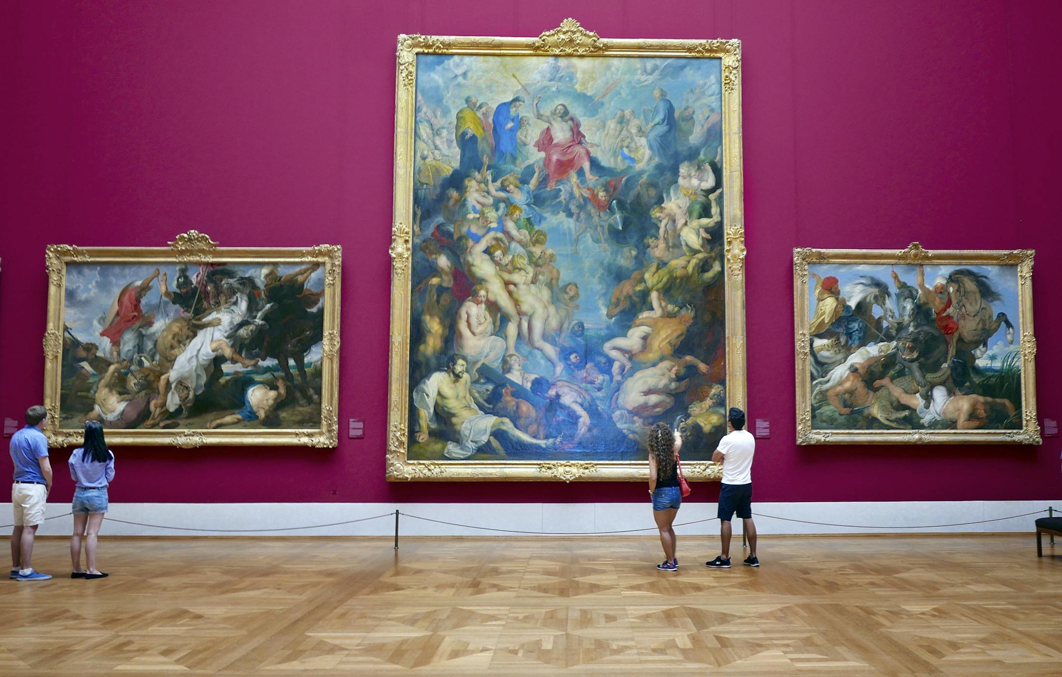 Peter Paul Rubens' 1617 painting "The Great Last Judgement," originally intended to hang over a church altar, is now in Munich's Alte Pinakothek museum, above. Top right, this ghoulish sculpture is among the lavish decorations at Munich's Asamkirche (Asam church), completed in 1746. Top left, locals picnic at Viktualienmarkt, where flowers, cheese, sausages and souvenirs are for sale.