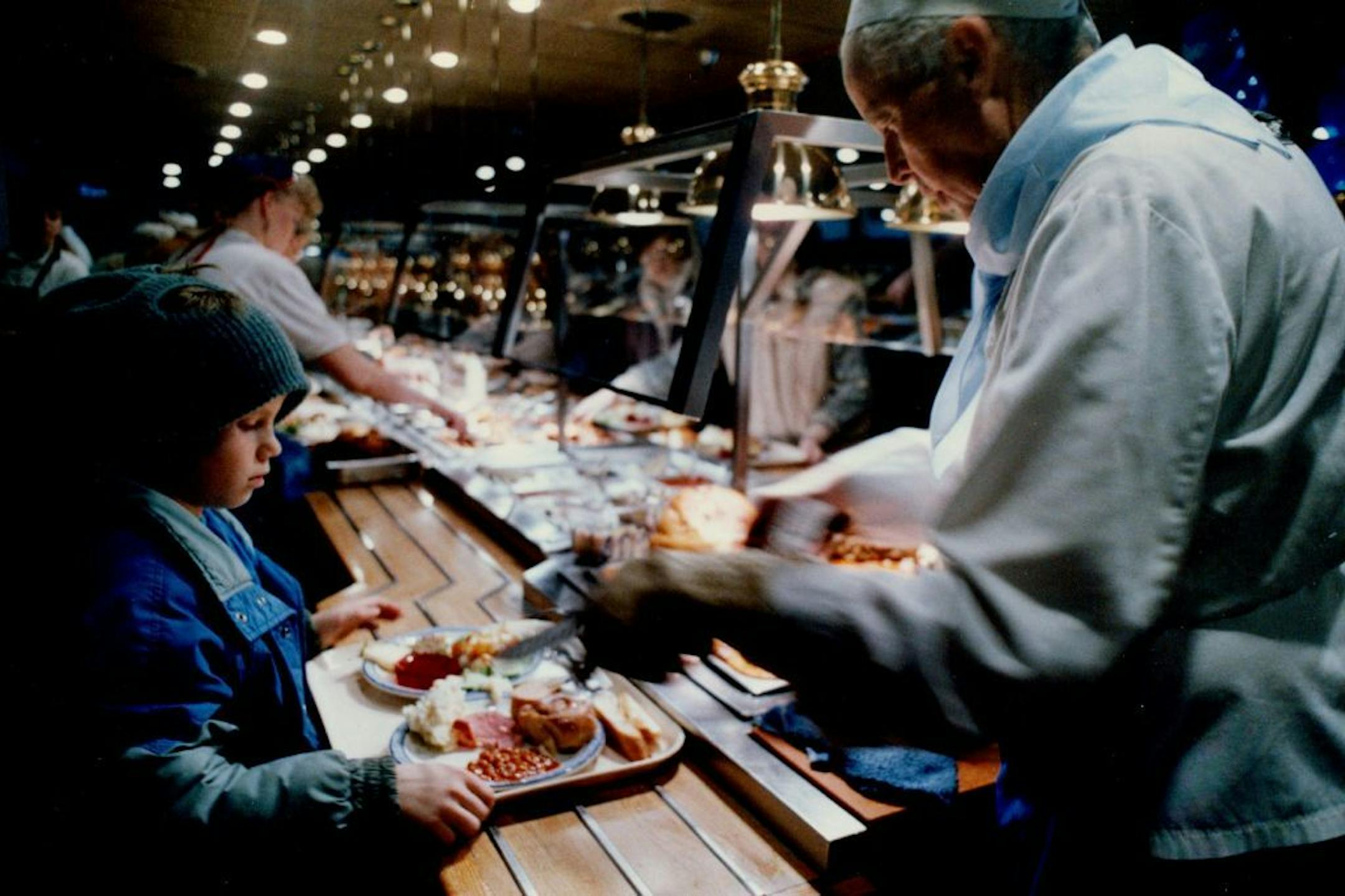 March 22, 1989 Celebrating growth Chef Ed Shelton served 8-year-old Jason Holt a slice of roast beef Tuesday at the Old Country Buffet, 9 E. 66th St., Richfield. Cofounders Roe Hatlen and Dennis Scott gave food away from 11 A.M. to 8 P.M. as part of a celebration marking the fifth anniversary of the company, which has grown from one to 60 outlets. They specialize in serving basic family fare. Jason, of Apple Valley, was visiting his grandmother. March 21, 1989 Duane Braley, Minneapolis Star Trib