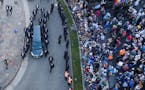 The hearse carrying the casket of Diego Maradona leaves the government house in Buenos Aires, Argentina, Thursday, Nov. 26, 2020.