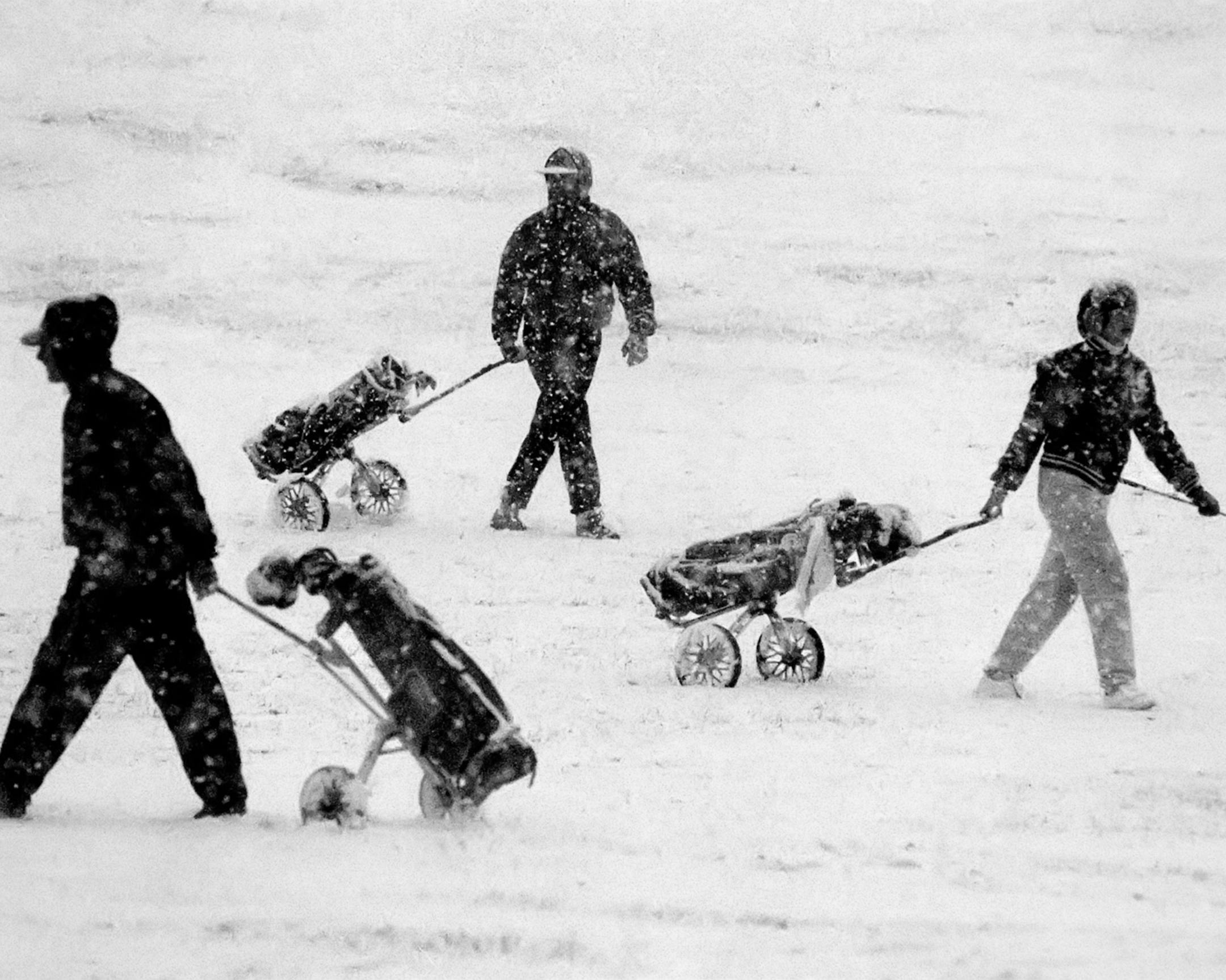 FILE -- Golfers negotiate snowy conditions at the Birnamwood Golf Course in Burnsville in 2013.