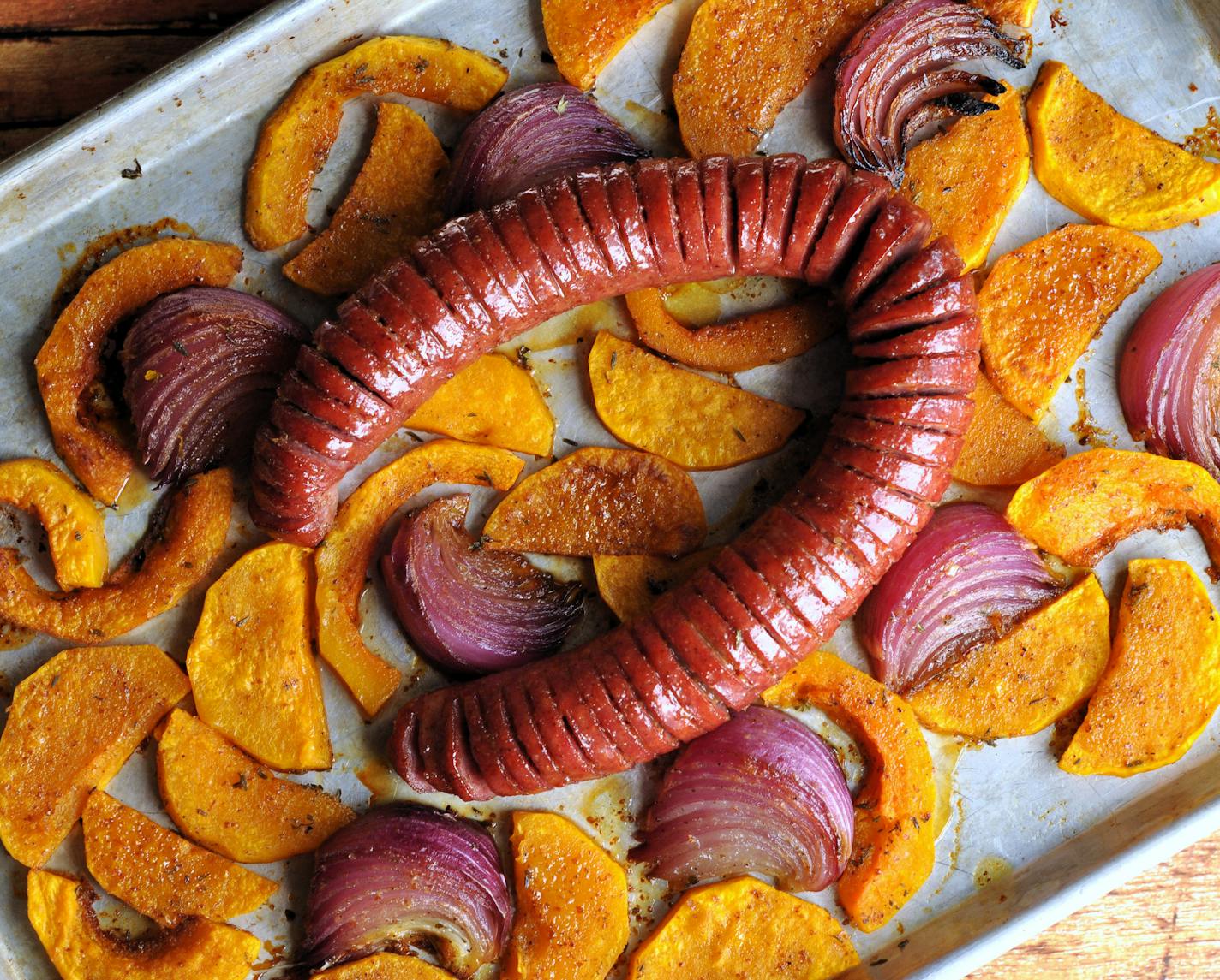 Glazed hasselback kielbasa, roasted with squash and red onions, is a tasty one-dish dinner. Recipe and photo by Meredith Deeds, Special to the Star Tribune