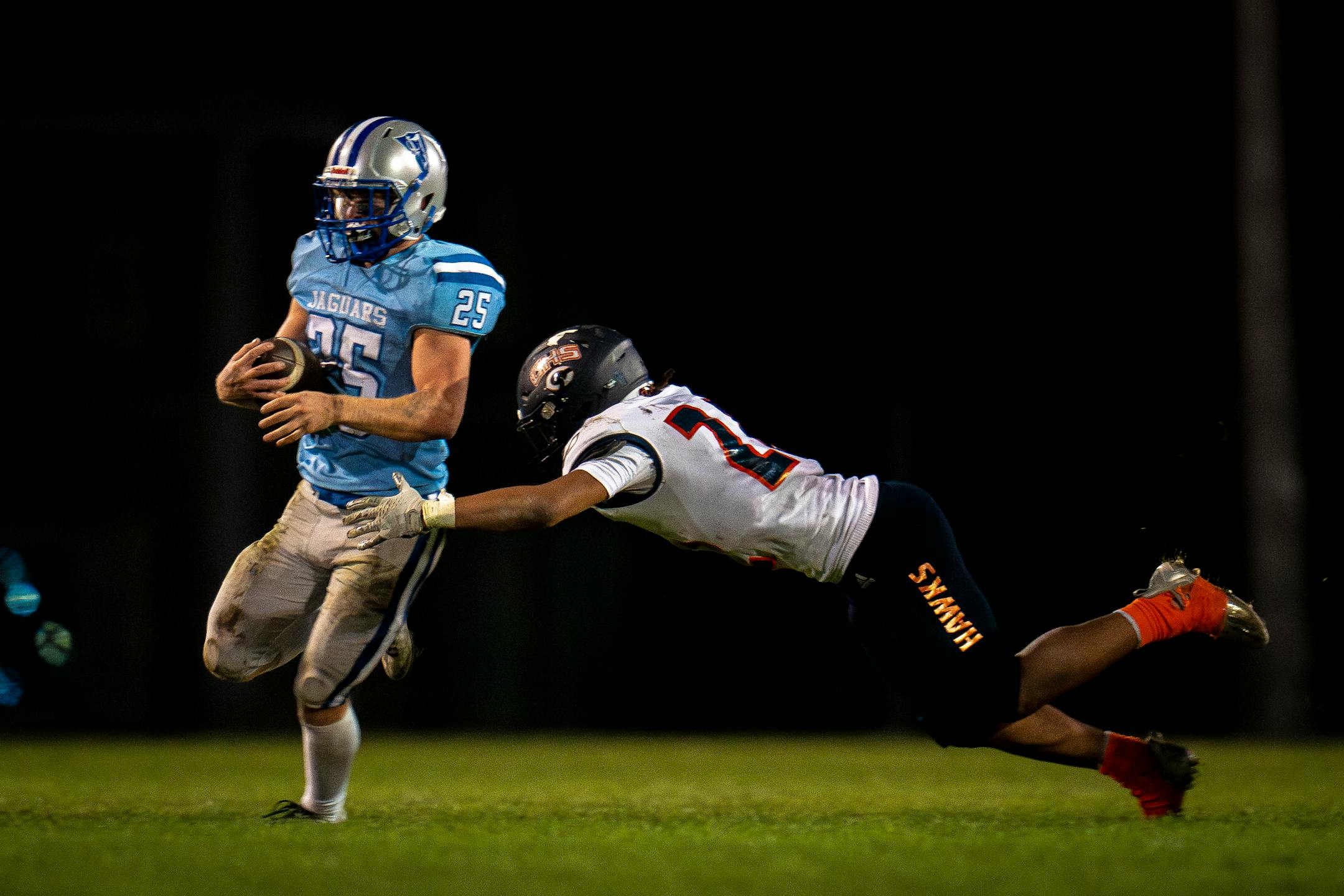 Bloomington Jefferson's Jonathan Weber (25) evades a tackle by Robbinsdale Cooper's Ray Heiland (22) Friday night.