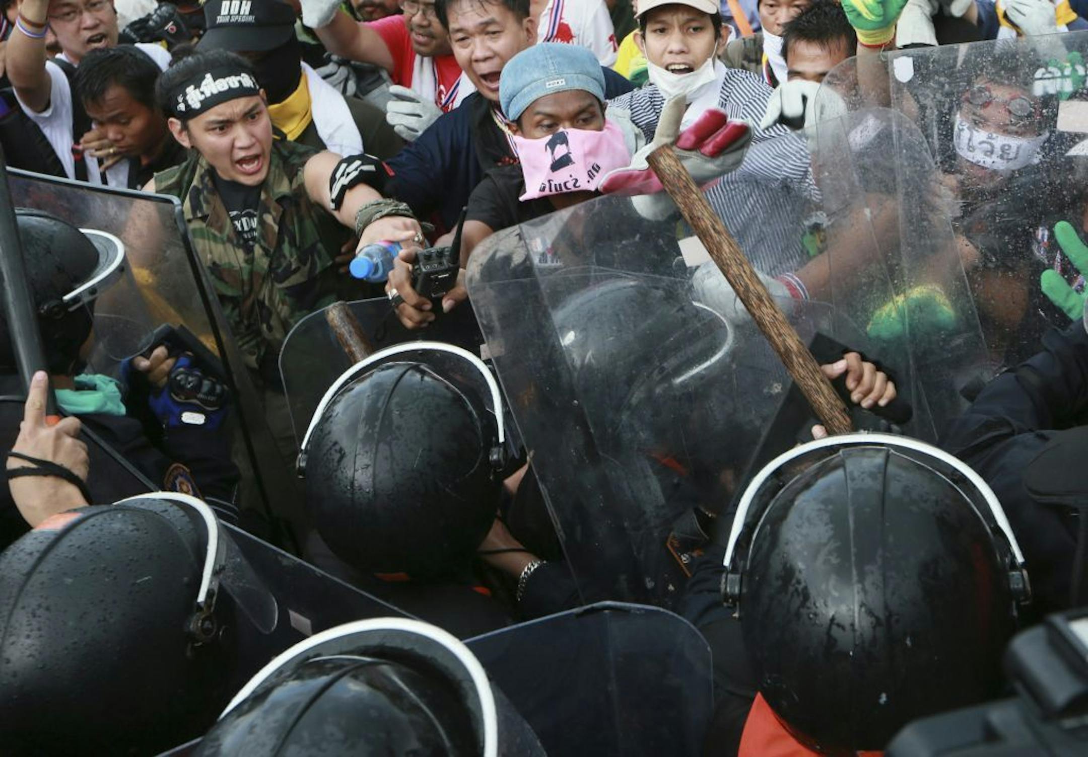 Anti-government protesters confront with riot police during a rally in Bangkok, Thailand, Monday, Nov. 25, 2013.