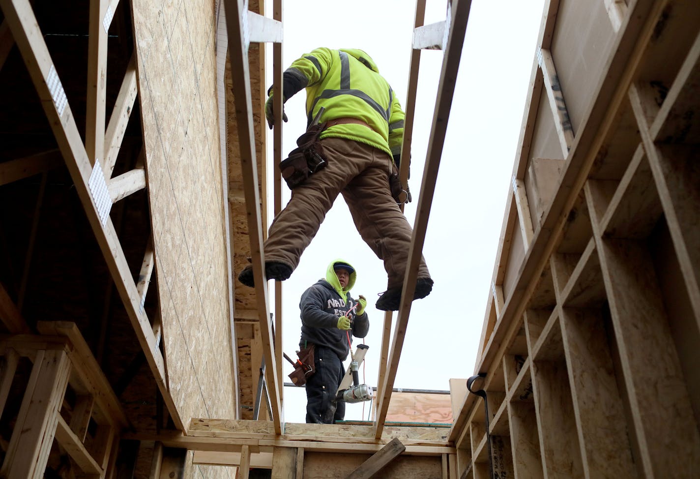 Shade Tree Construction carpenters and brothers Juan Alejos, front, Eddie Alejos work on building a 2,100 square foot, three bedroom, three bath, side by side model townhome Wednesday, Nov. 28, 2018, in Mounds View, MN.] DAVID JOLES &#x2022; david.joles@startribune.com Home building in the Twin Cities is in the midst of a seasonal slowdown, but sales of entry level new houses have been robust. Buildable lots that are affordable to entry level buyers, however, are in short supply.** Juan Alejos ,